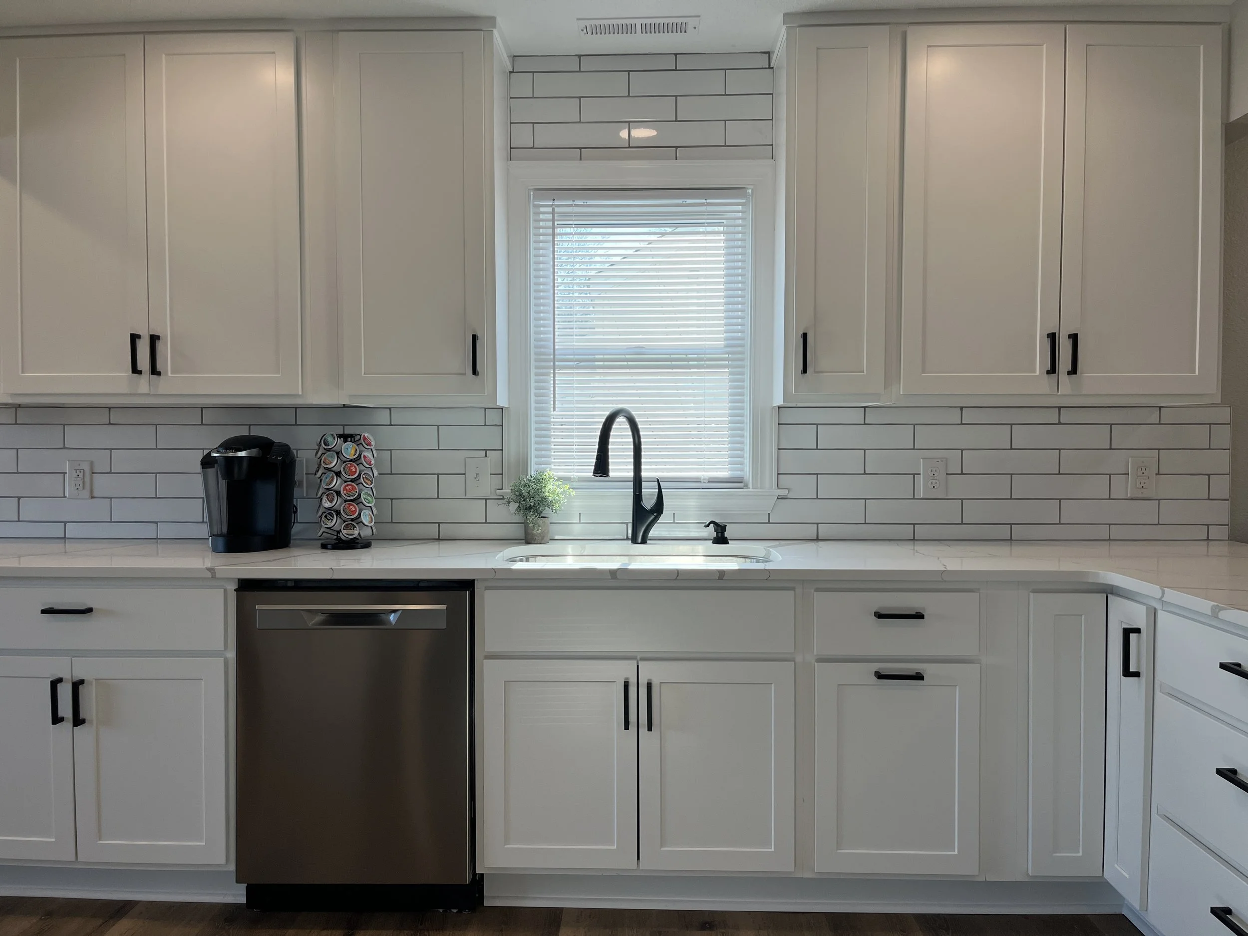 Complete kitchen remodeling with custom cabinetry, countertops, tile backsplash, and modern finishes. Residential kitchen renovation featuring new cabinets, countertops, backsplash tile, plumbing fixtures, and flooring.