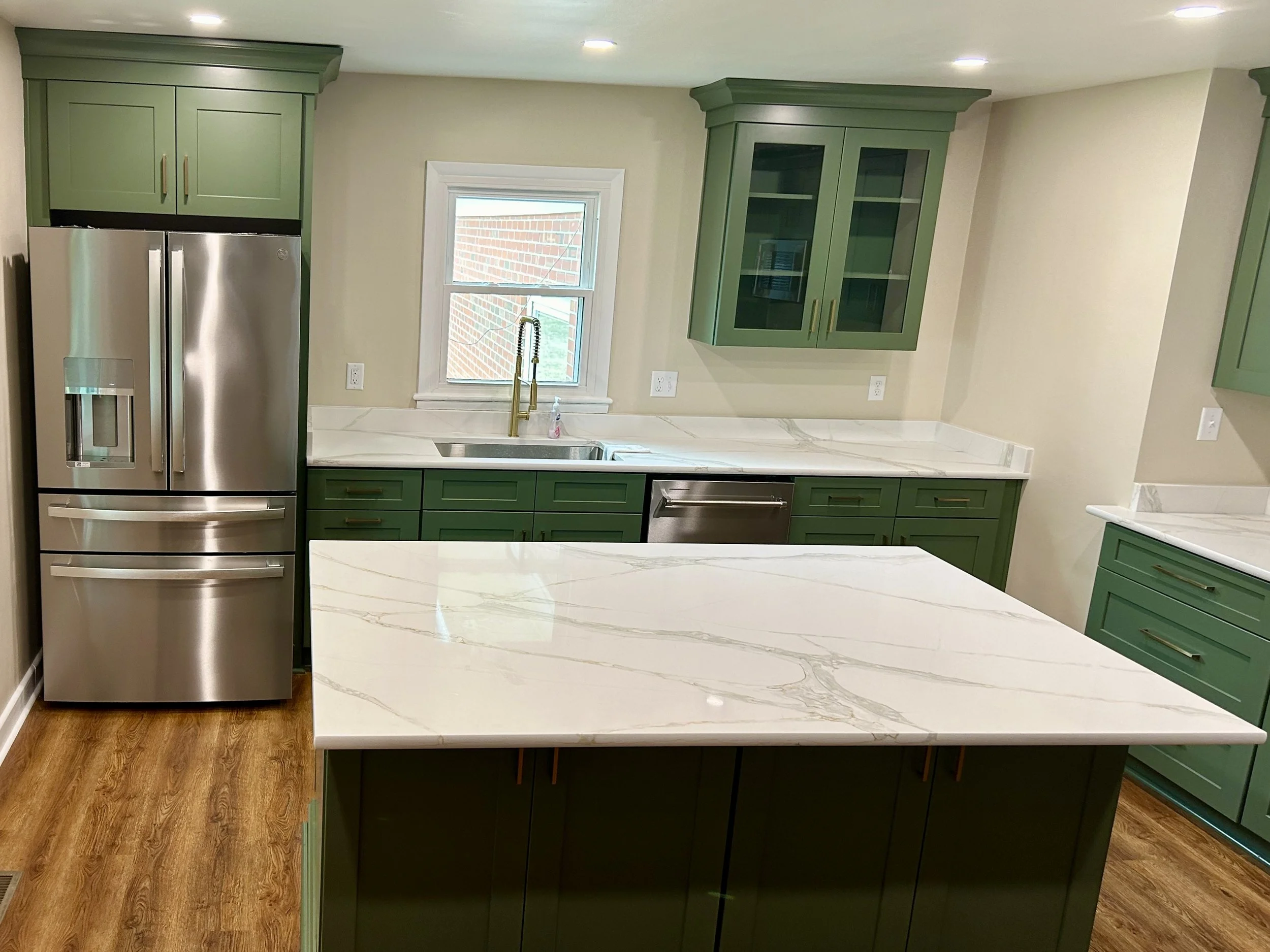 Complete kitchen remodeling with custom cabinetry, countertops, tile backsplash, and modern finishes. Residential kitchen renovation featuring new cabinets, countertops, backsplash tile, plumbing fixtures, and flooring.