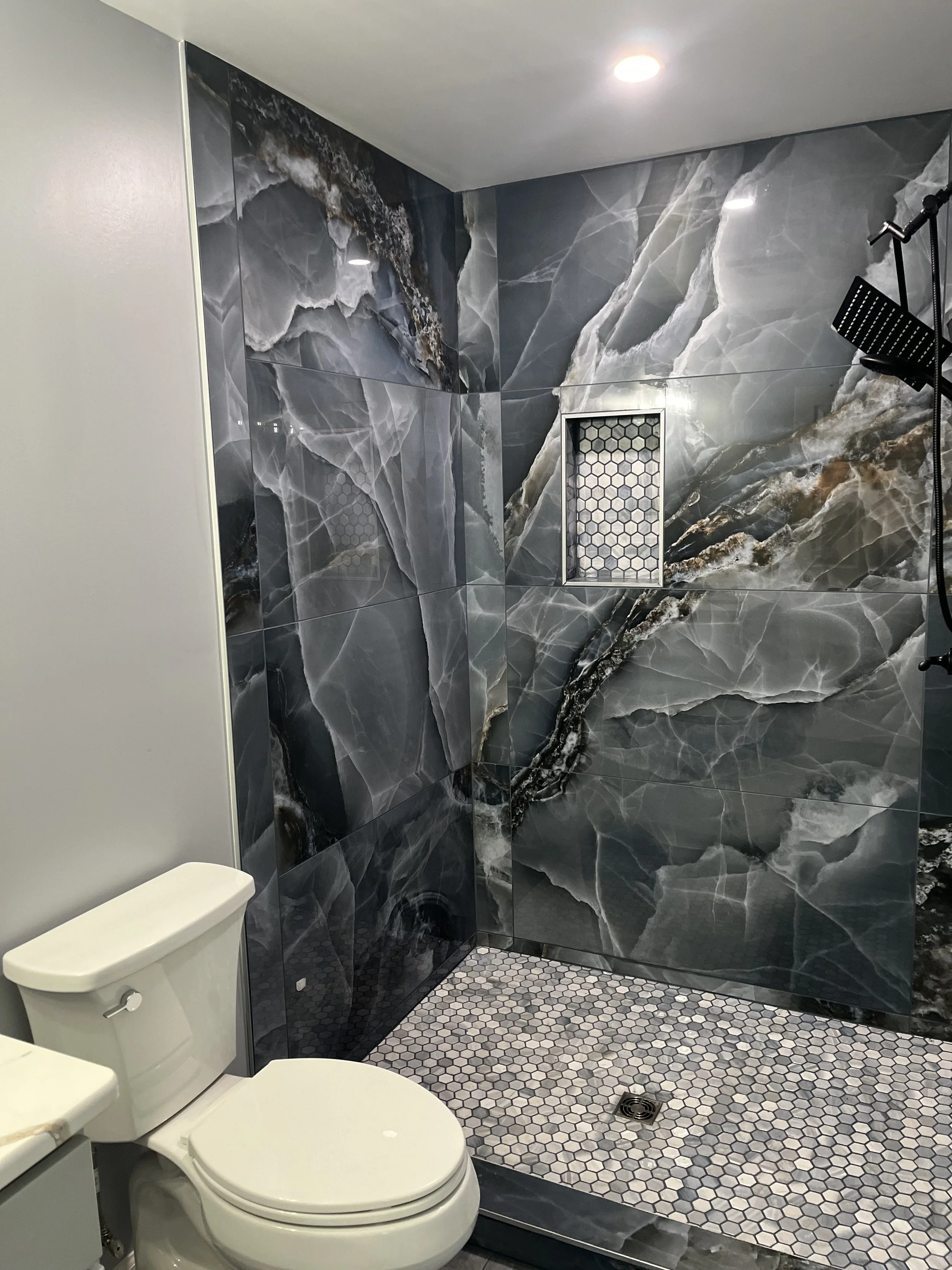 Professional bathroom remodeling and renovation with custom tile, cabinetry, and modern fixtures.Residential bathroom renovation featuring professional tile installation, updated cabinetry, modern plumbing fixtures, and custom layouts.