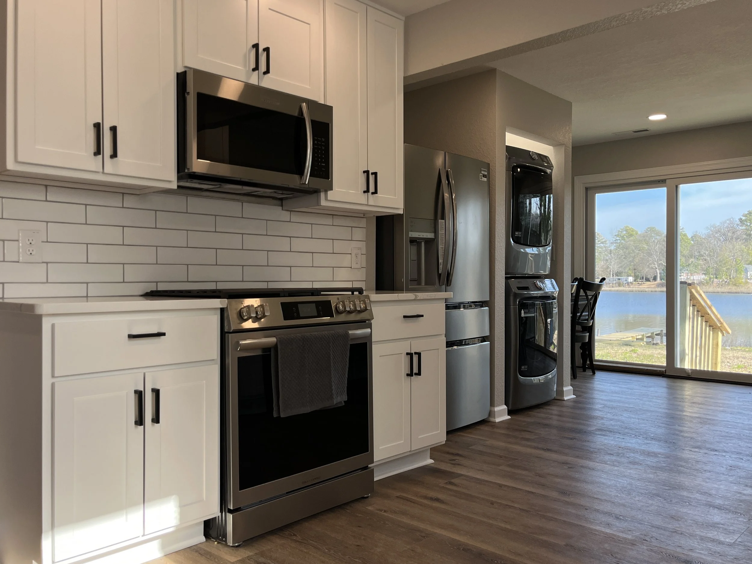 Complete kitchen remodeling with custom cabinetry, countertops, tile backsplash, and modern finishes. Residential kitchen renovation featuring new cabinets, countertops, backsplash tile, plumbing fixtures, and flooring.