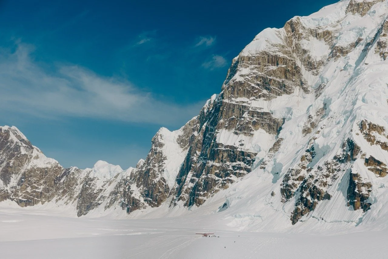 Alaska Cruise. Snow-covered mountains under a clear blue sky with some clouds