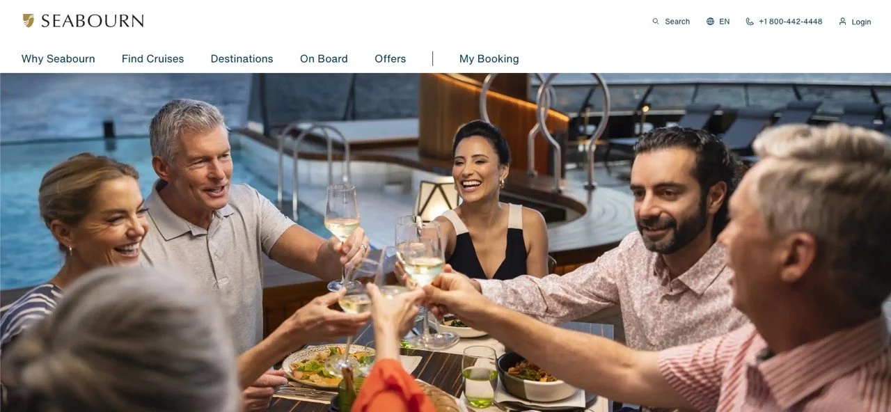 A group of happy people enjoying a toast with white wine on a boat or yacht, with a pool and modern seating in the background.