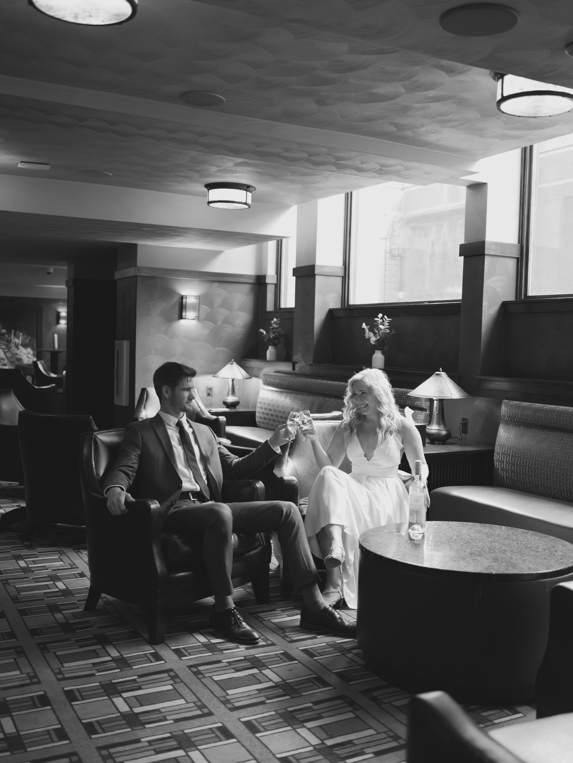 Bride and groom sitting in wedding attire.