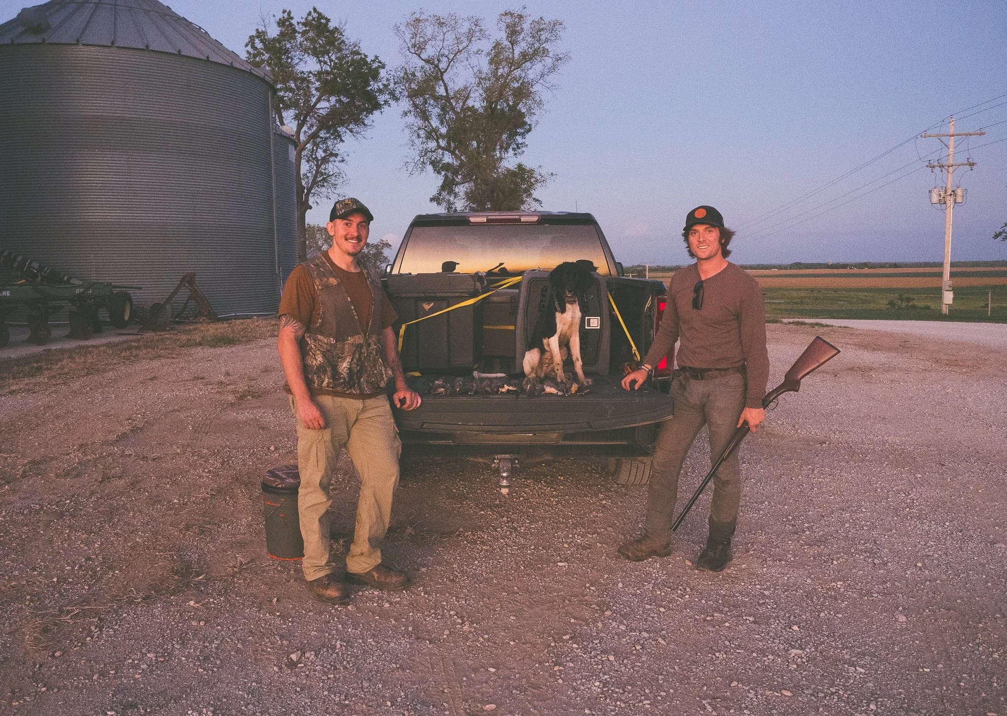 Aldo, a five month old Large Munsterlander versatile hunting dog, sits on the tailgate with a limit of doves after his first dove hunt.
