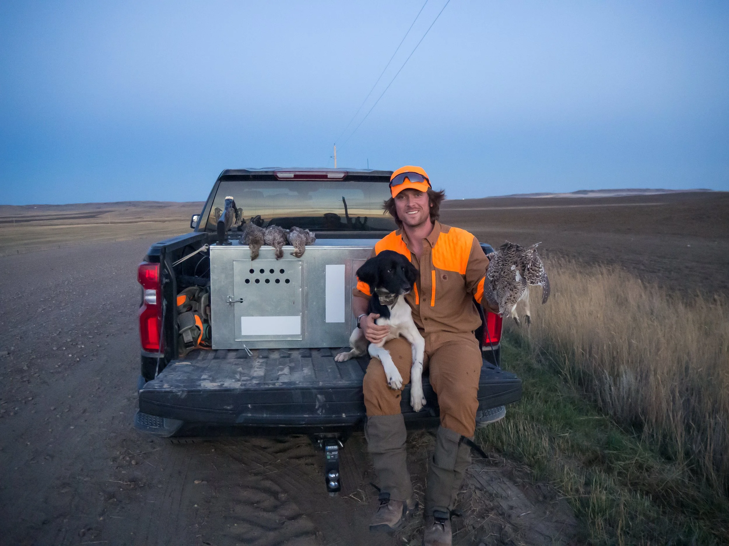 Ian Burrow with his dog Aldo in Montana with a daily limit of Sharp-tailed grouse.