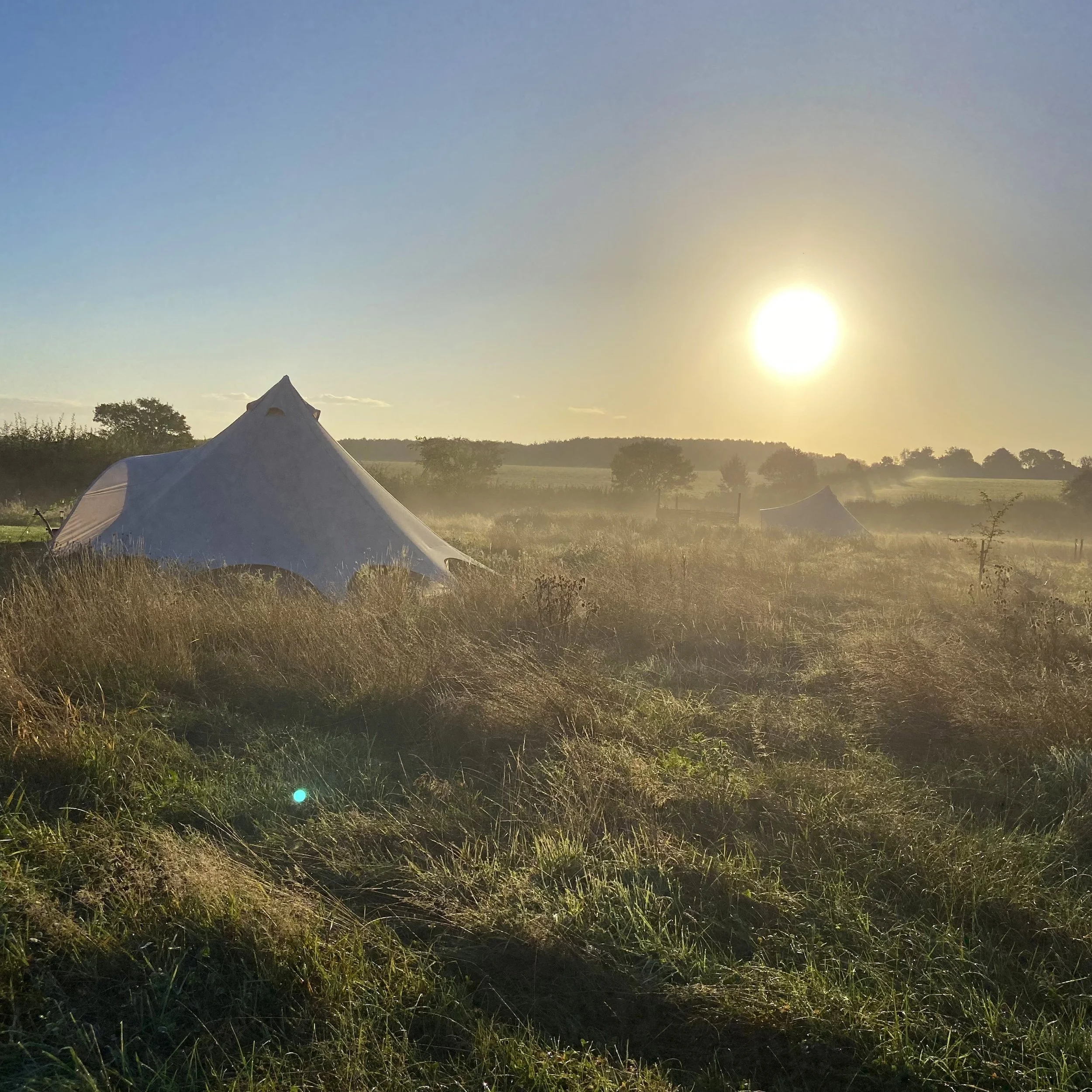 Sunrise over luxury bell tents at Broadleaves Glamping near Donington Park