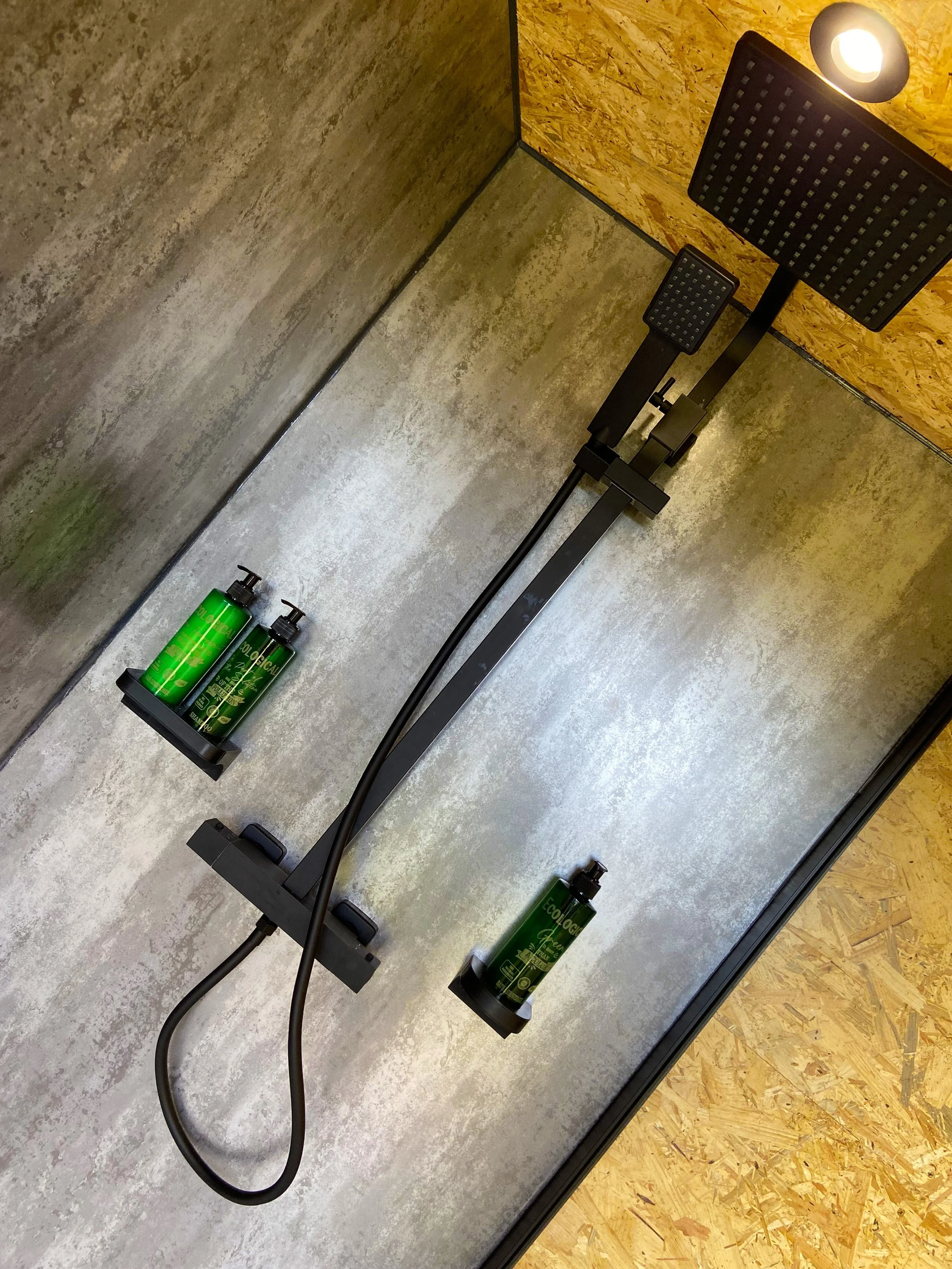 Luxury rainfall shower in the modern bathroom building at Broadleaves Glamping with complimentary toiletries.