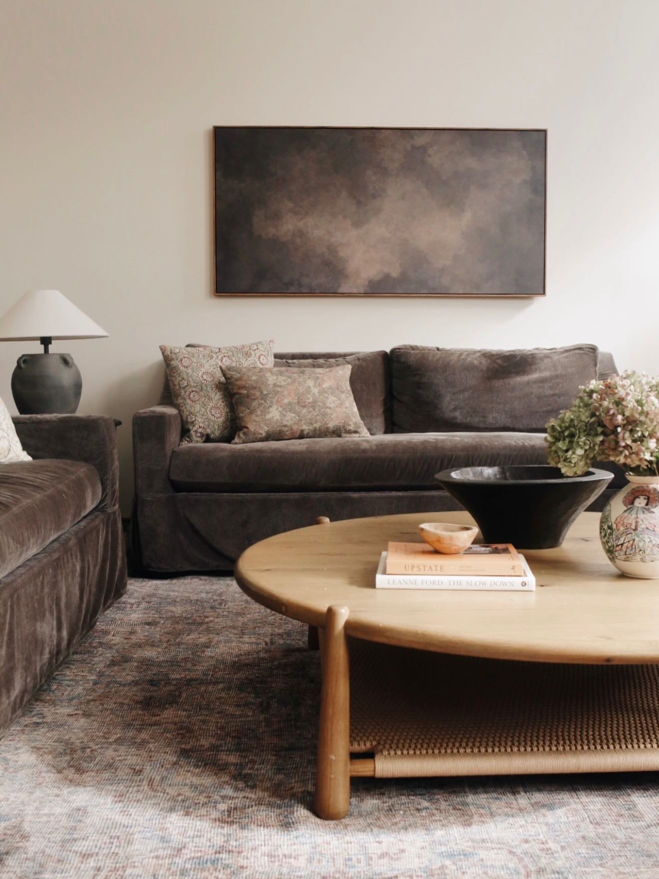 This family reached out to me after moving to a larger home with an open living room floor plan and a big, blank wall. The goal was to create a cozier, more conversational space but the floor plan wasn&rsquo;t making sense with their sectional sofa. 