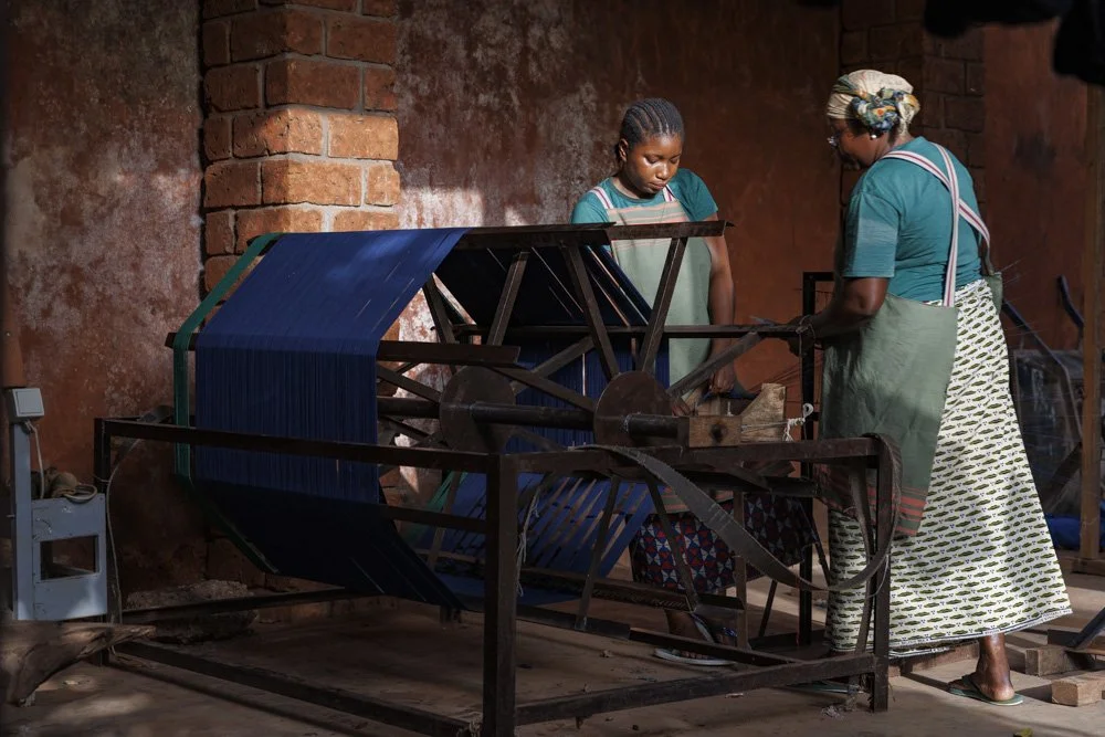 Emilie Traore(R) and Quedulaogo N’djouk Mariam(L) perform sectional wrapping of yarn at the Xoomba studio in Bolomakoté, Bobo Dioulasso, Burkina Faso.
