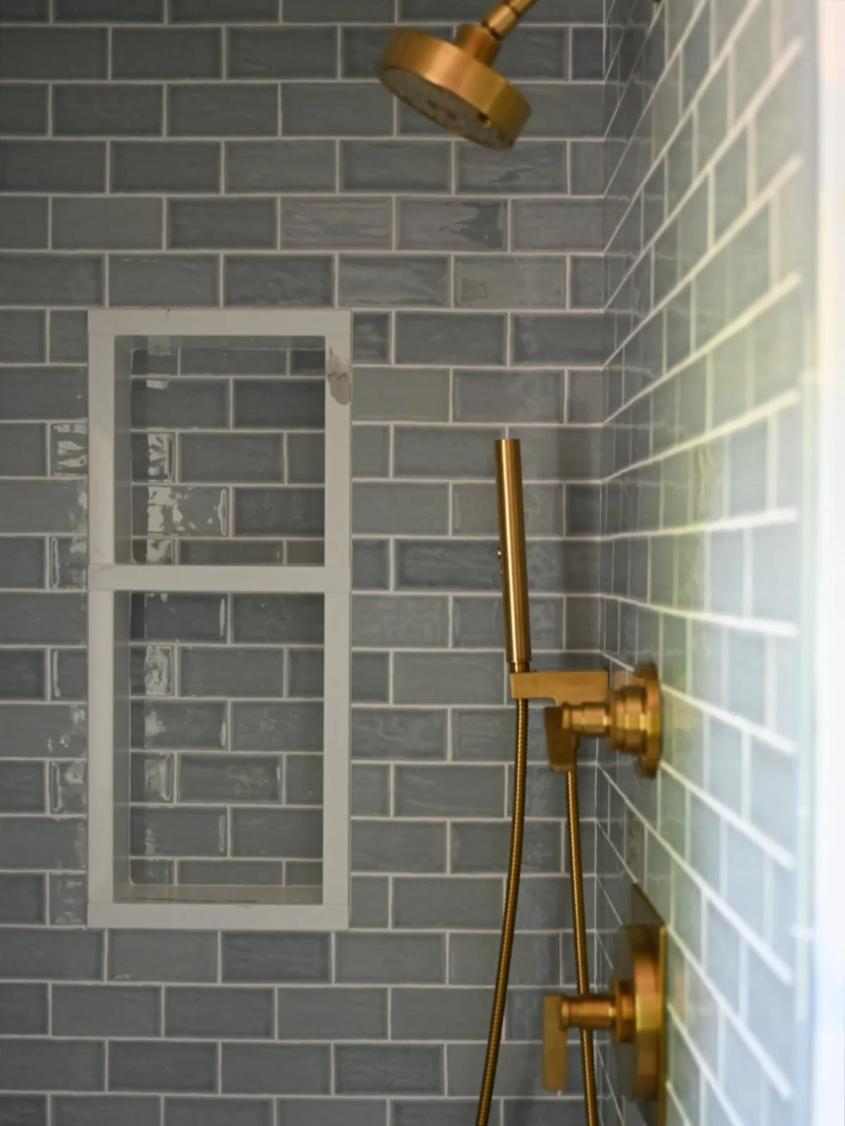 3 shower details we ALWAYS implement:

- Always check the rough-in height and centering locations before tile is installed. 

- The niche should always play nicely with the tile pattern. Standard size niches almost never work because they land awkwar