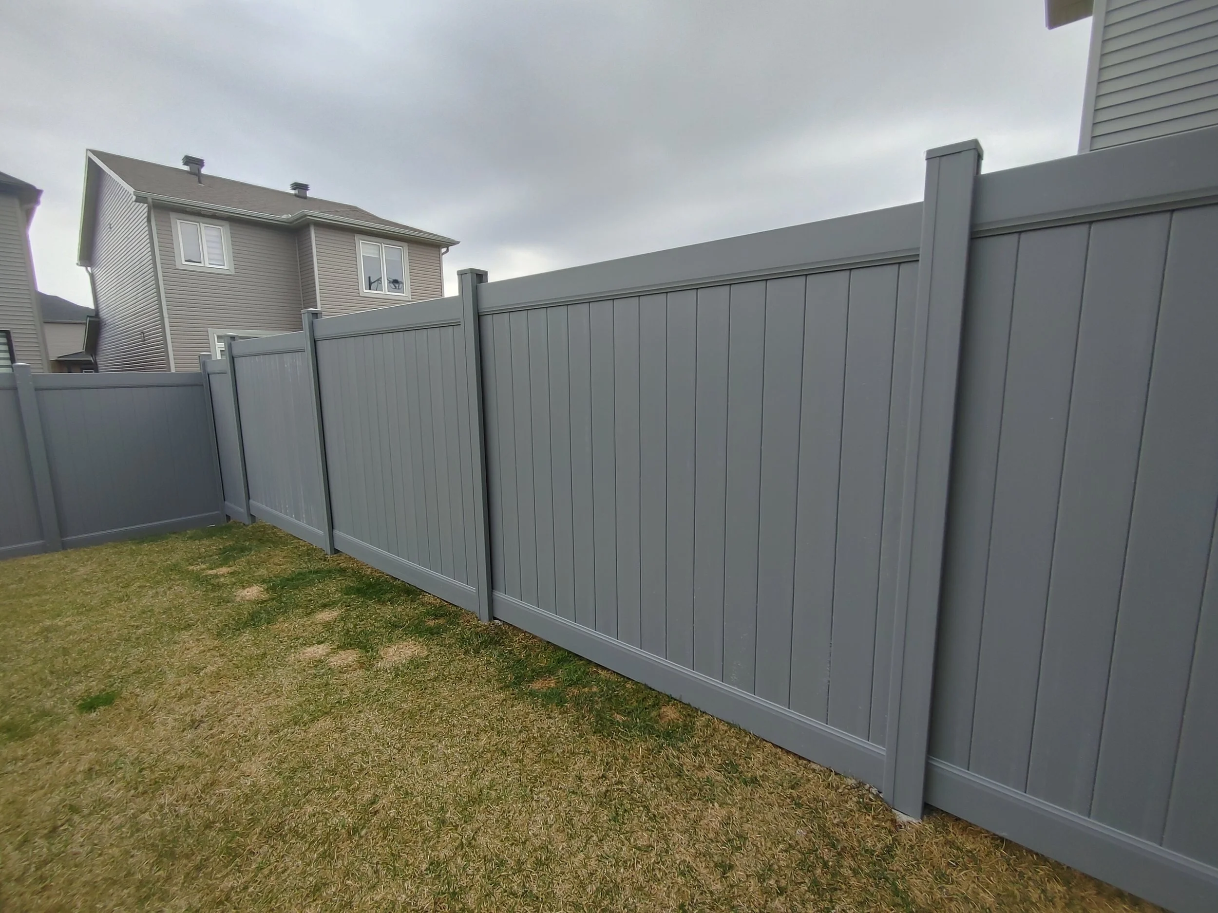 Grey PVC Fence in Barrhaven, 2025. StandArt Fence 