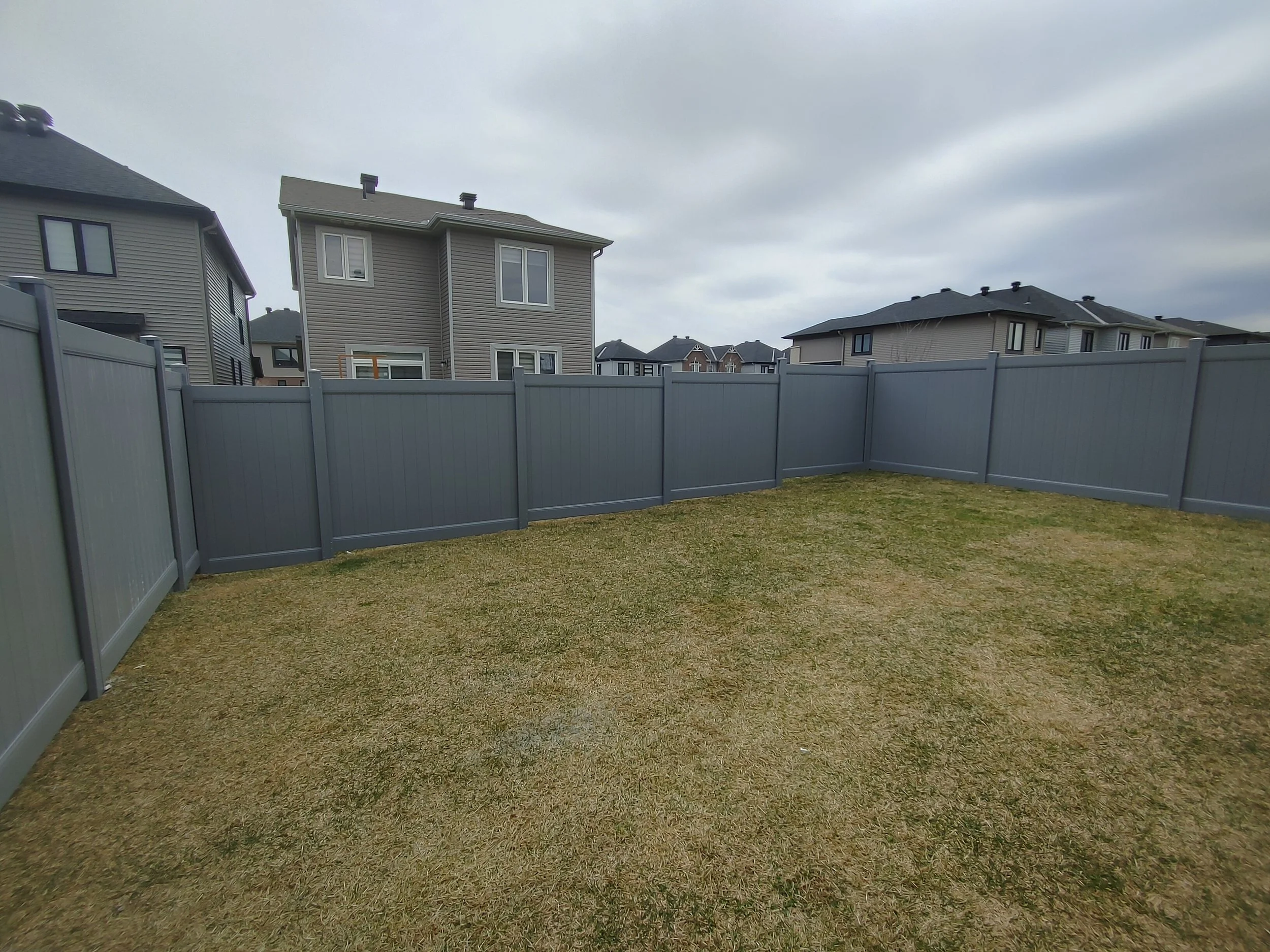 Grey PVC Fence in Barrhaven, 2025. StandArt Fence 