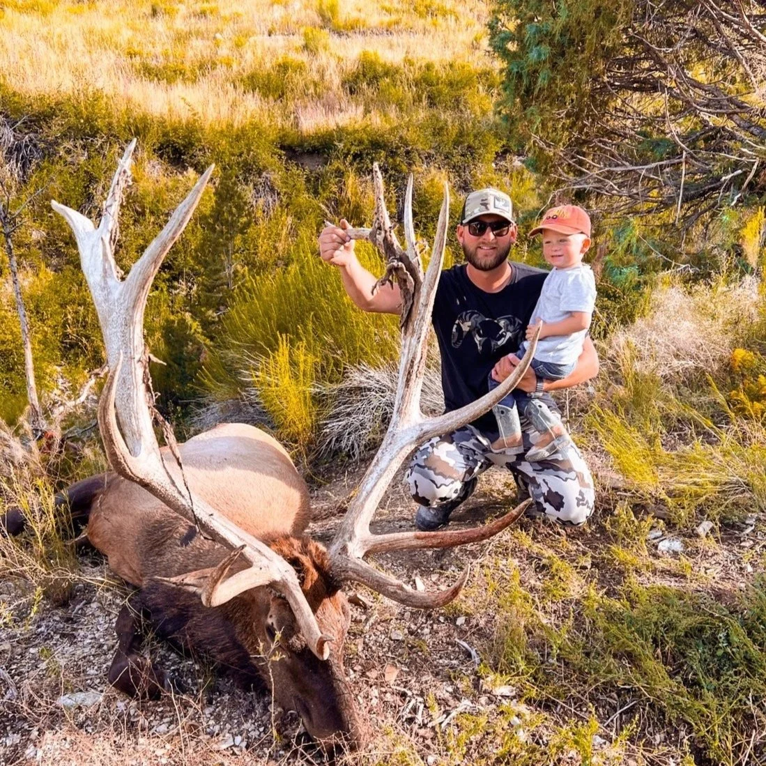John Dykster holding elk at SD Outfitters ranch with son