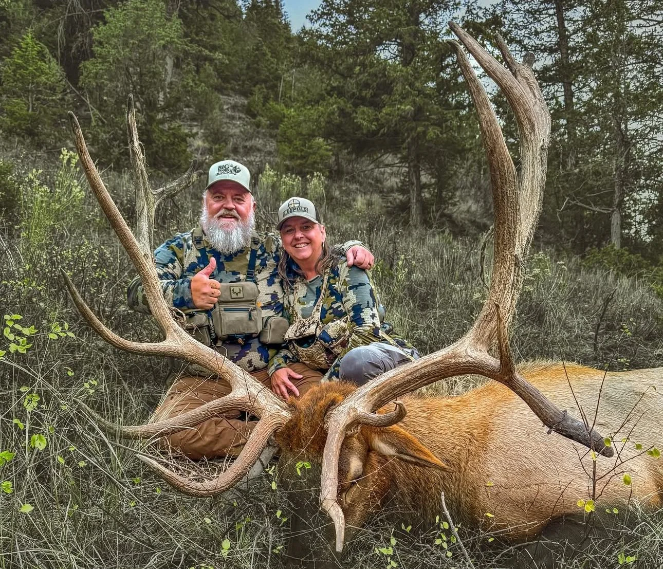 Hunter with trophy bull elk harvested on a guided private land elk hunt in Utah with SD Outfitters