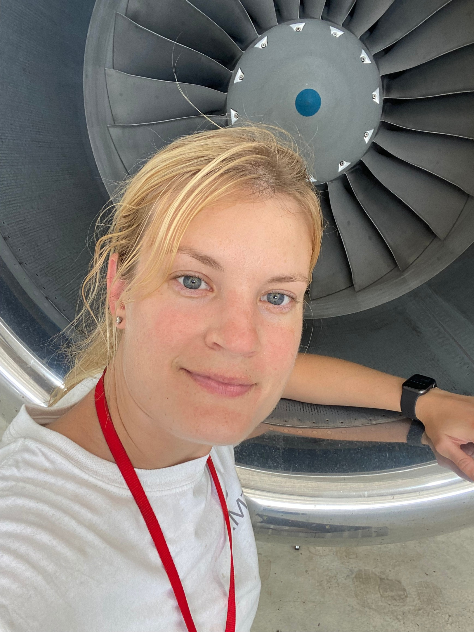 Photo of Corri Gidden standing in front of an airplane engine