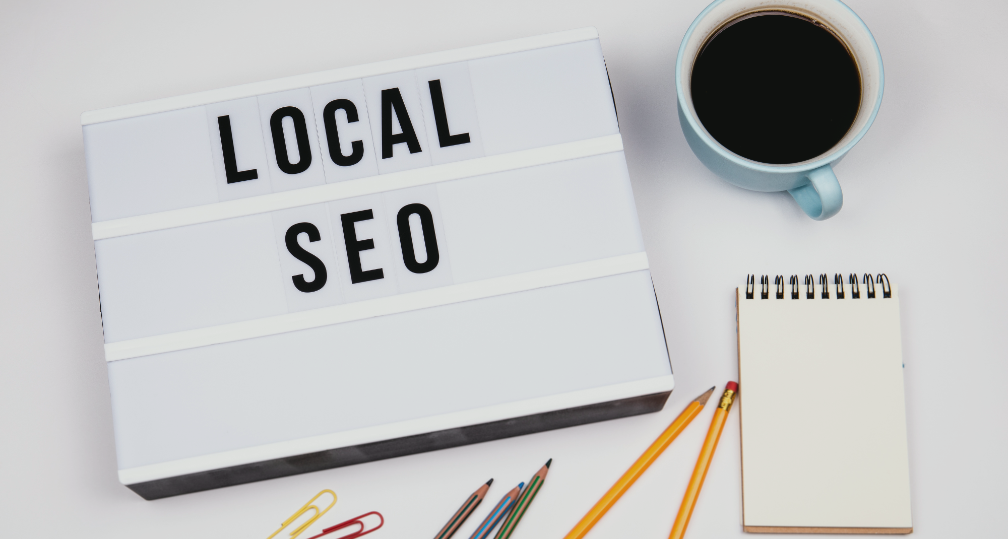 Local SEO sign sitting beside a cup of coffee