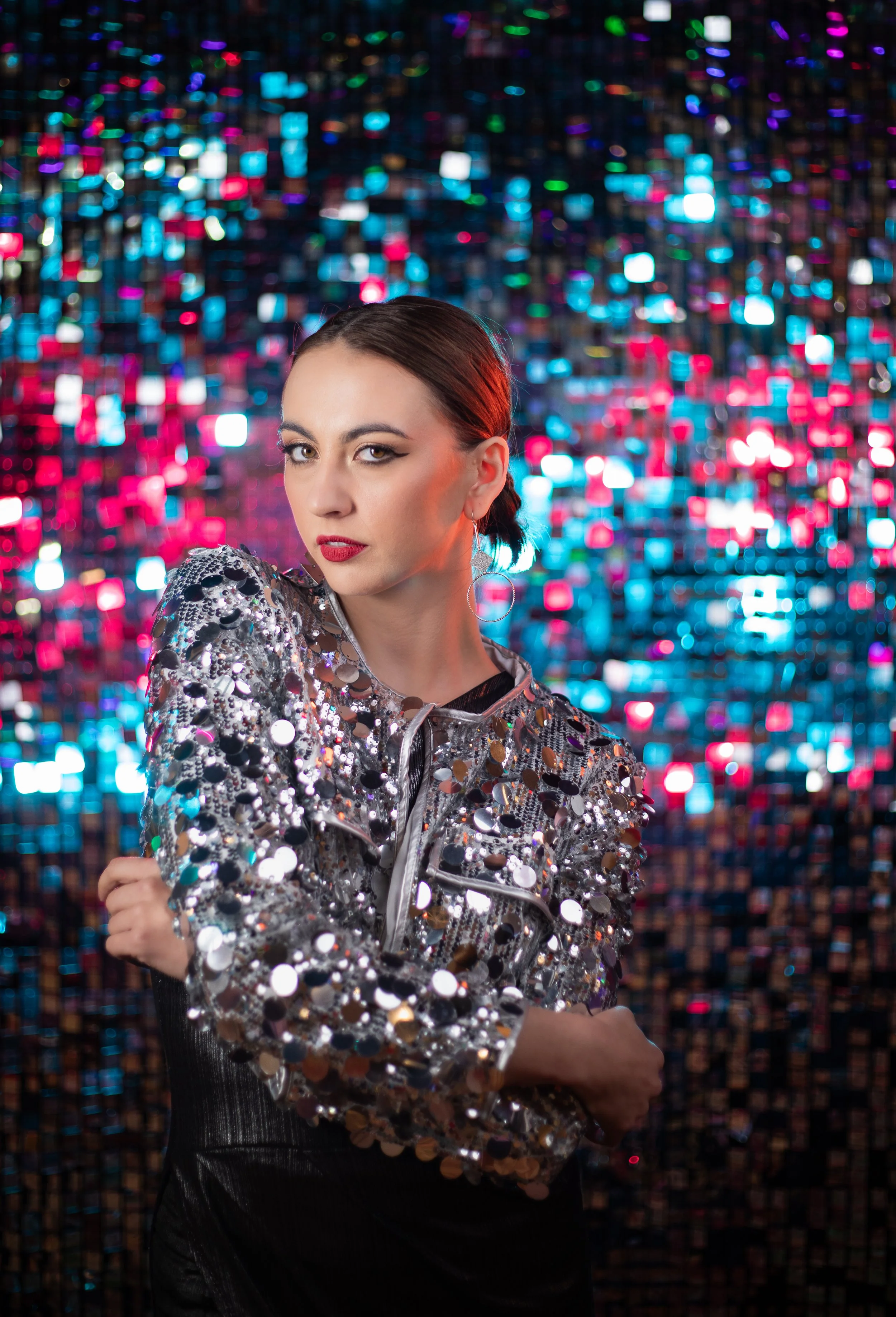 Woman wearing sequin jacket in a glitter room photographed by southern california annette marie fantasy photography.