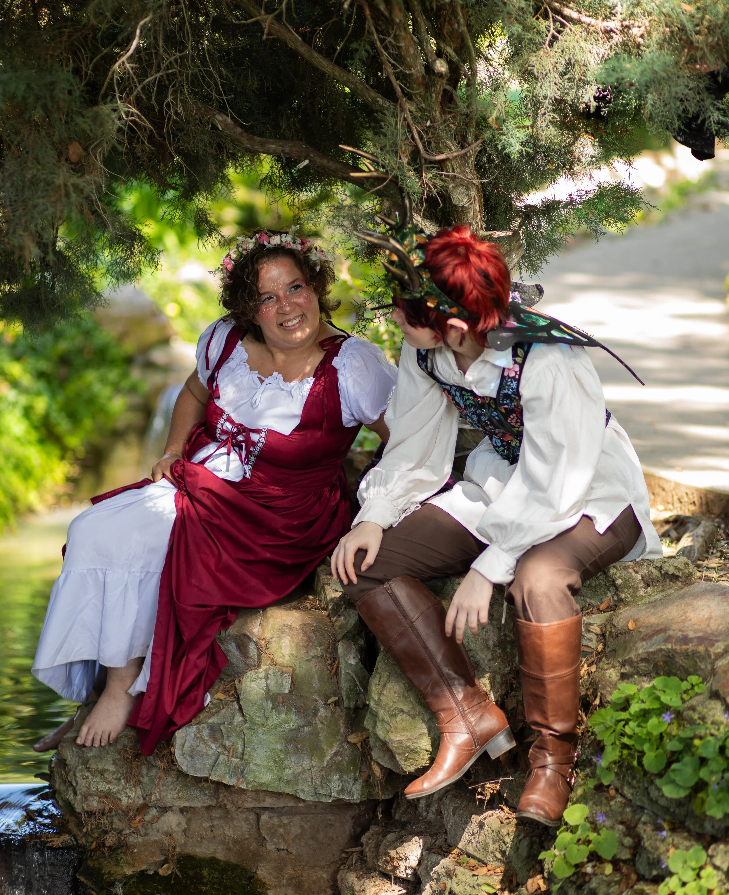 fantasy photographer captures mom and teen dressed in fairy clothing with wings and elf ears, flower crowns, and dresses. Annette marie photography.