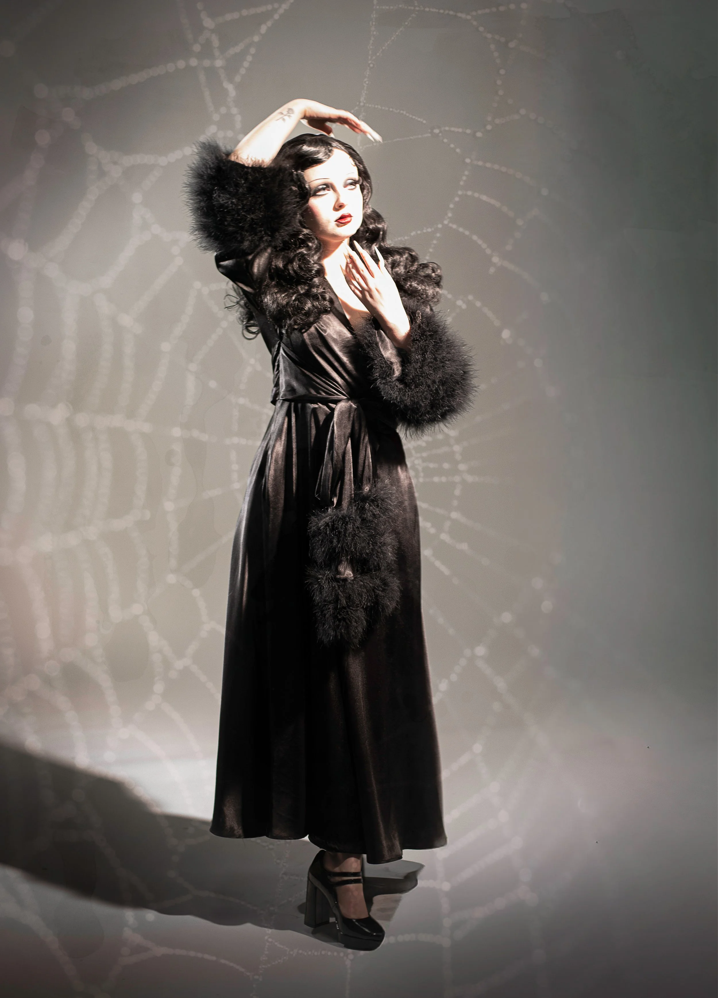 Woman dressed gothic in photo in studio with added spiderweb by fantasy photographer Annette Marie, in high desert.