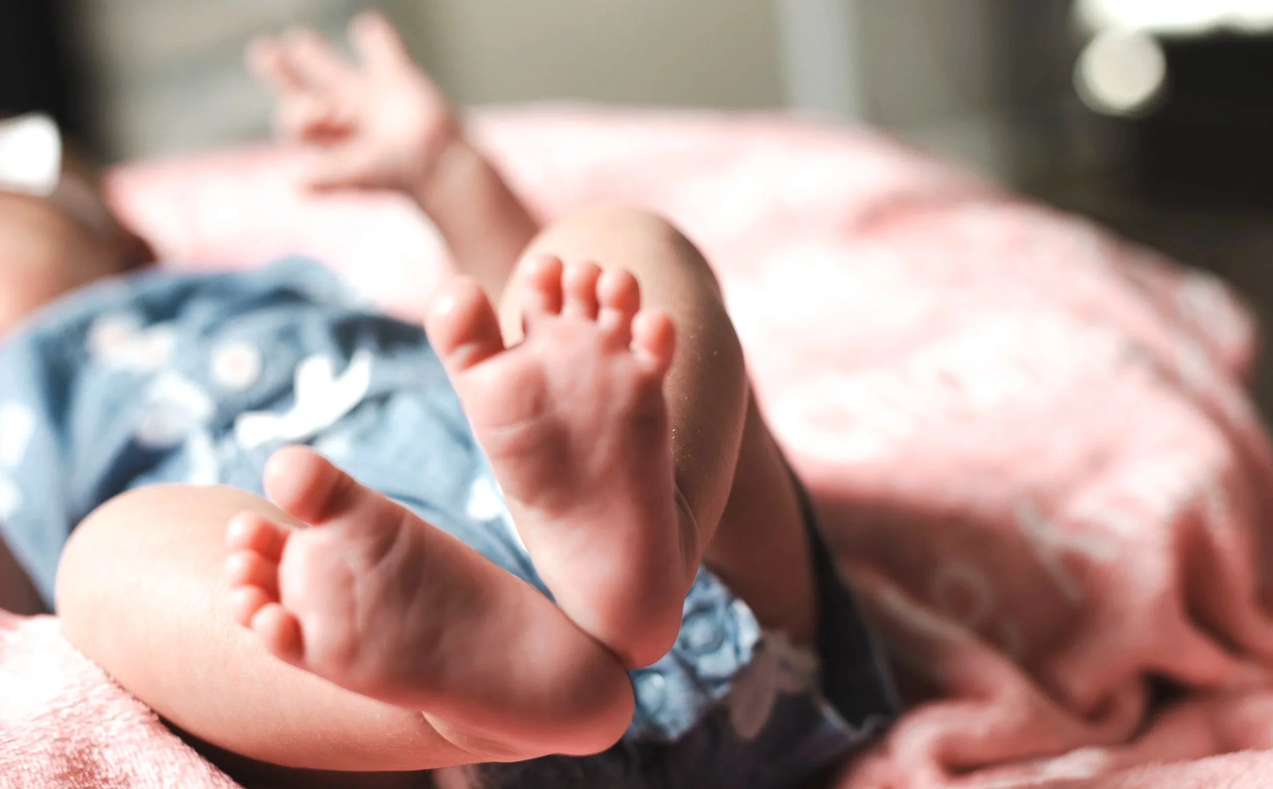 Newborn baby girl toes on a pink blanket by high desert family playful photographer.