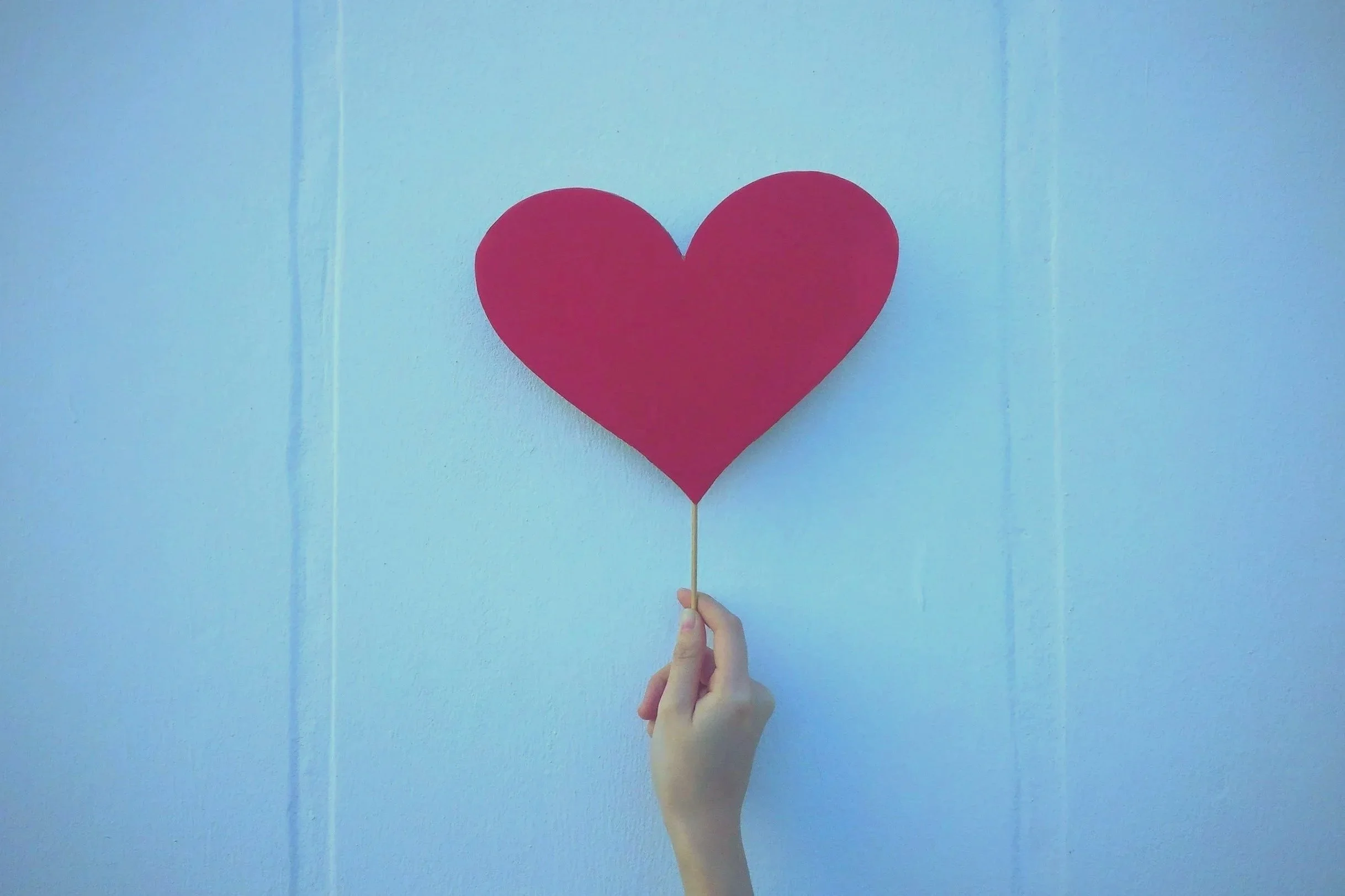 hand holding a paper heart