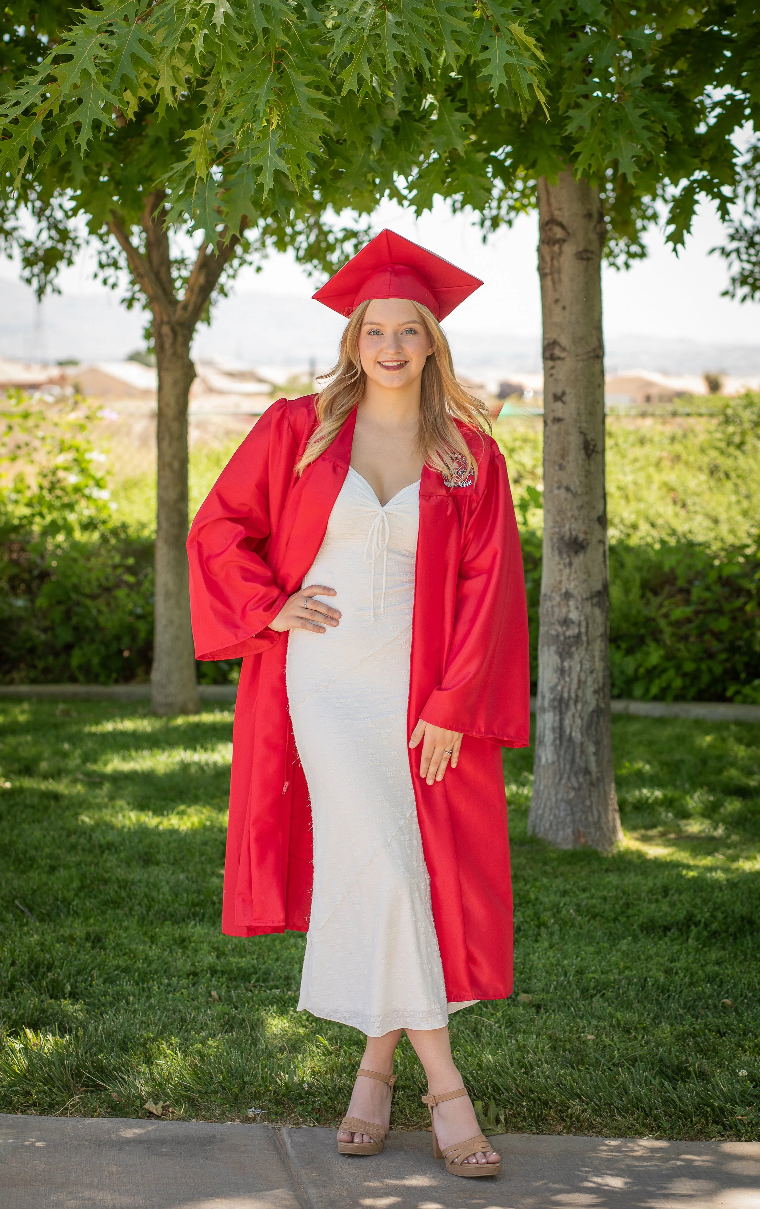 Oak Hills graduation girl with cap and gown in Hesperia, ca. 