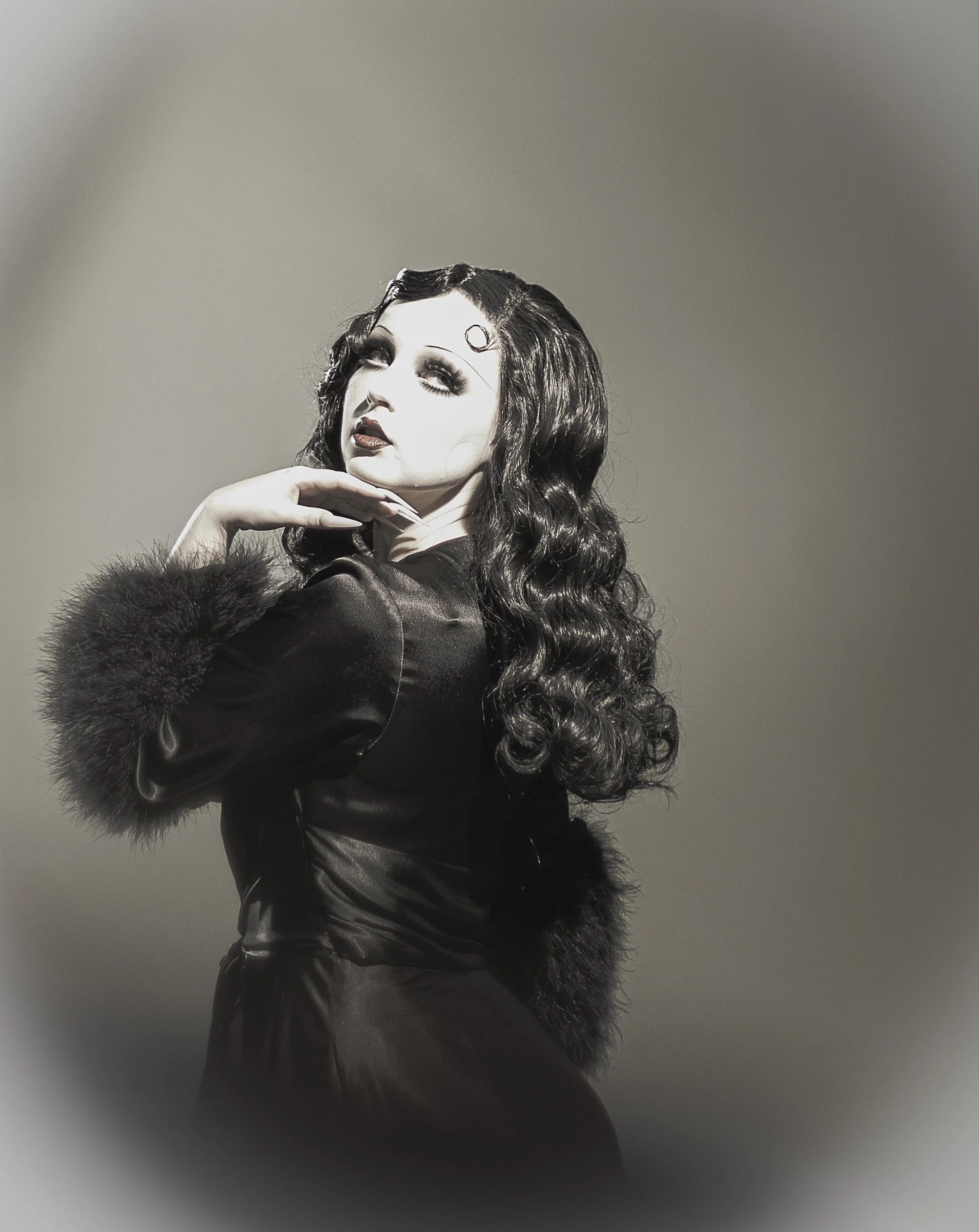 Gothic woman wearing robe and wig, fantasy photo makeup to look like betty boop, vintage 1920s era. In studio portrait High desert and Inland empire, Ca.