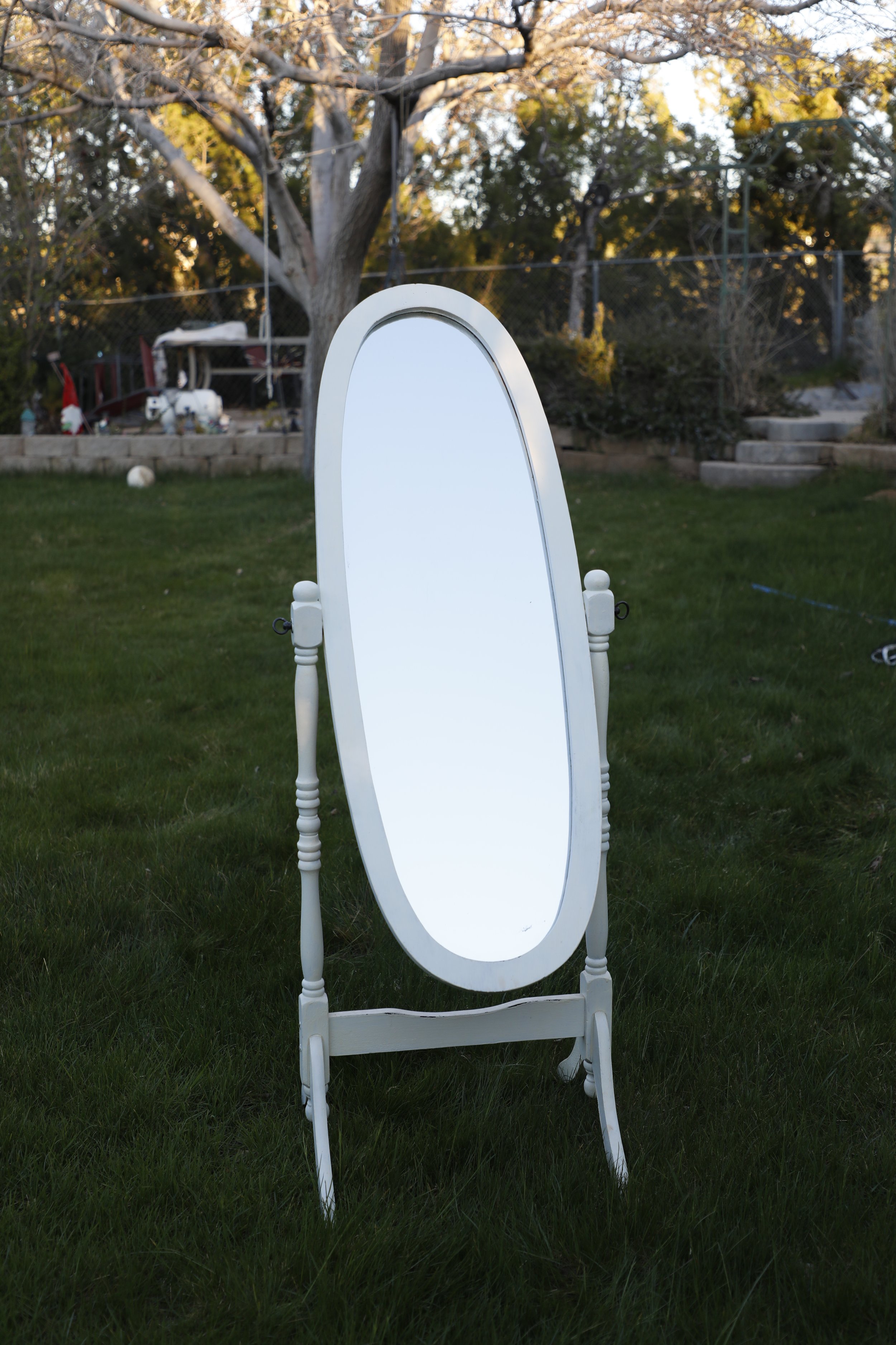 Mirror in a backyard for fantasy photography portraits. Annette Marie in southern california.