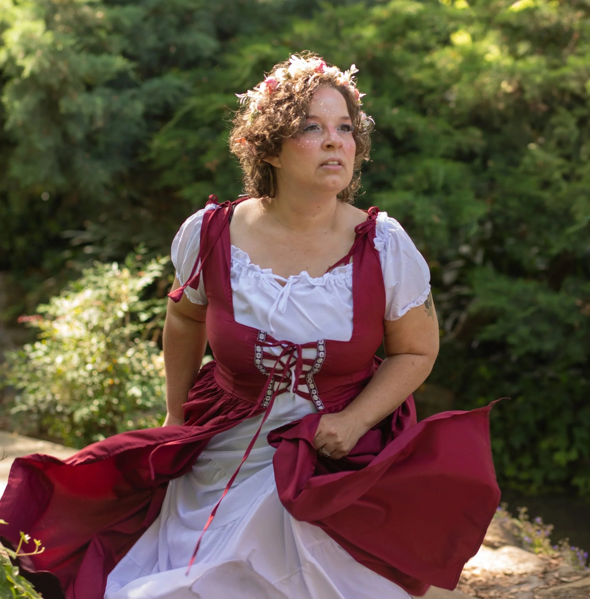 Woman running dressed in fairy dress, holding dress, by fantasy photographer in the southern california, high desert.