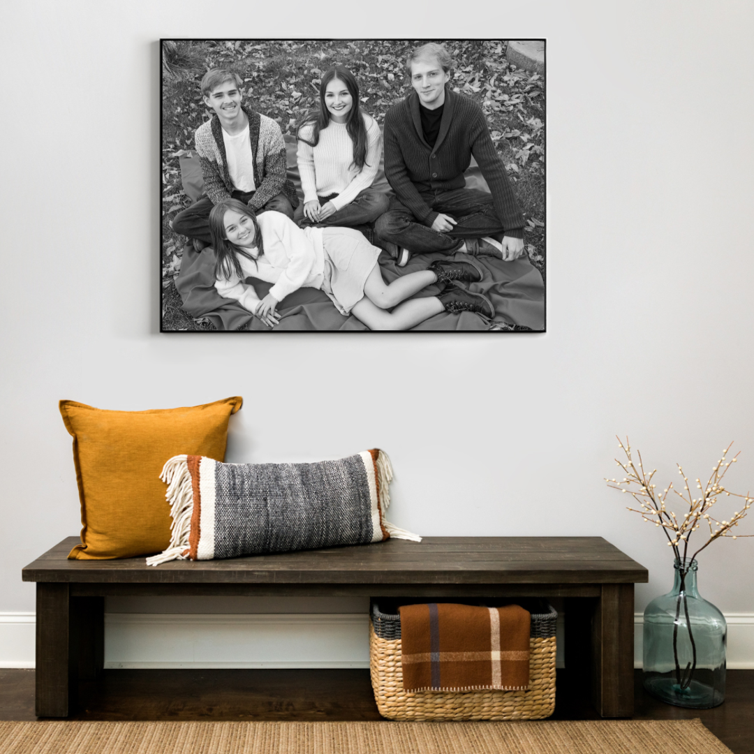 Family photo hung abover entry way bench with 4 people in black and white. Photographer that prints your photos for you, southern california.