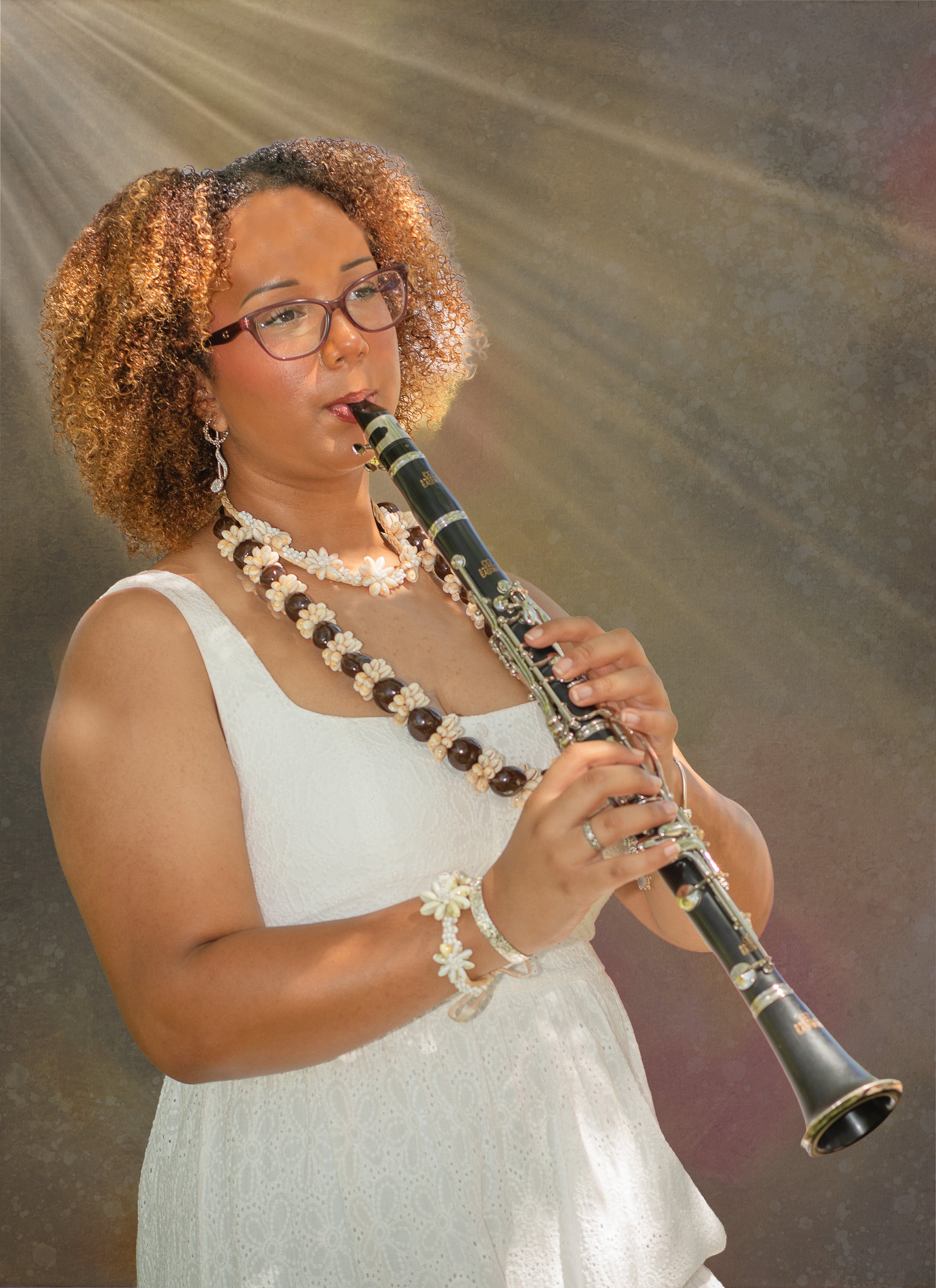 Fantasy fine art photographer in the inland empire. Photo of girl playing clarinet with sun ray over her head.