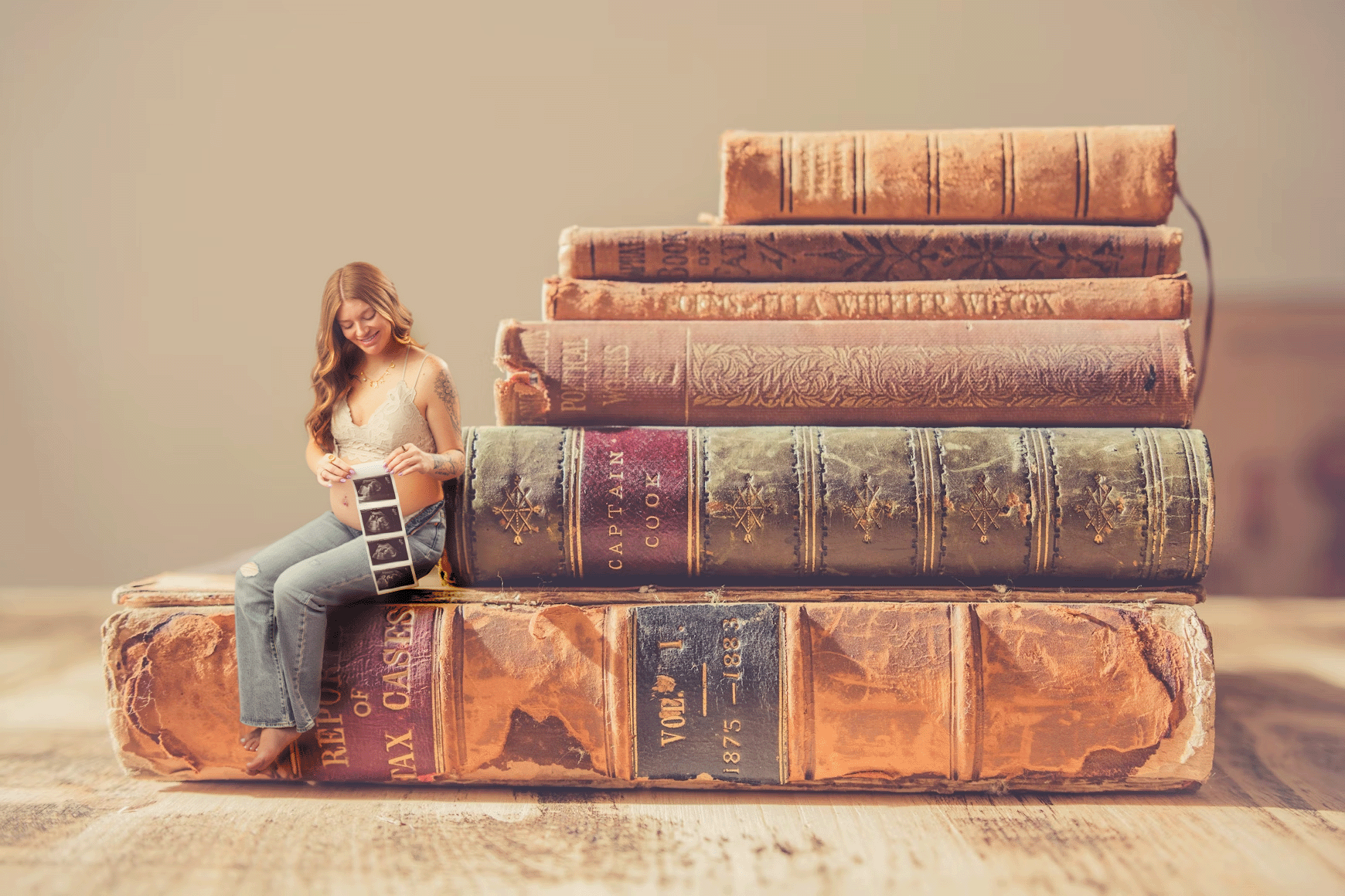 Book lovers maternity style photo session in pinon hills photography studio, by annette a family photographer.