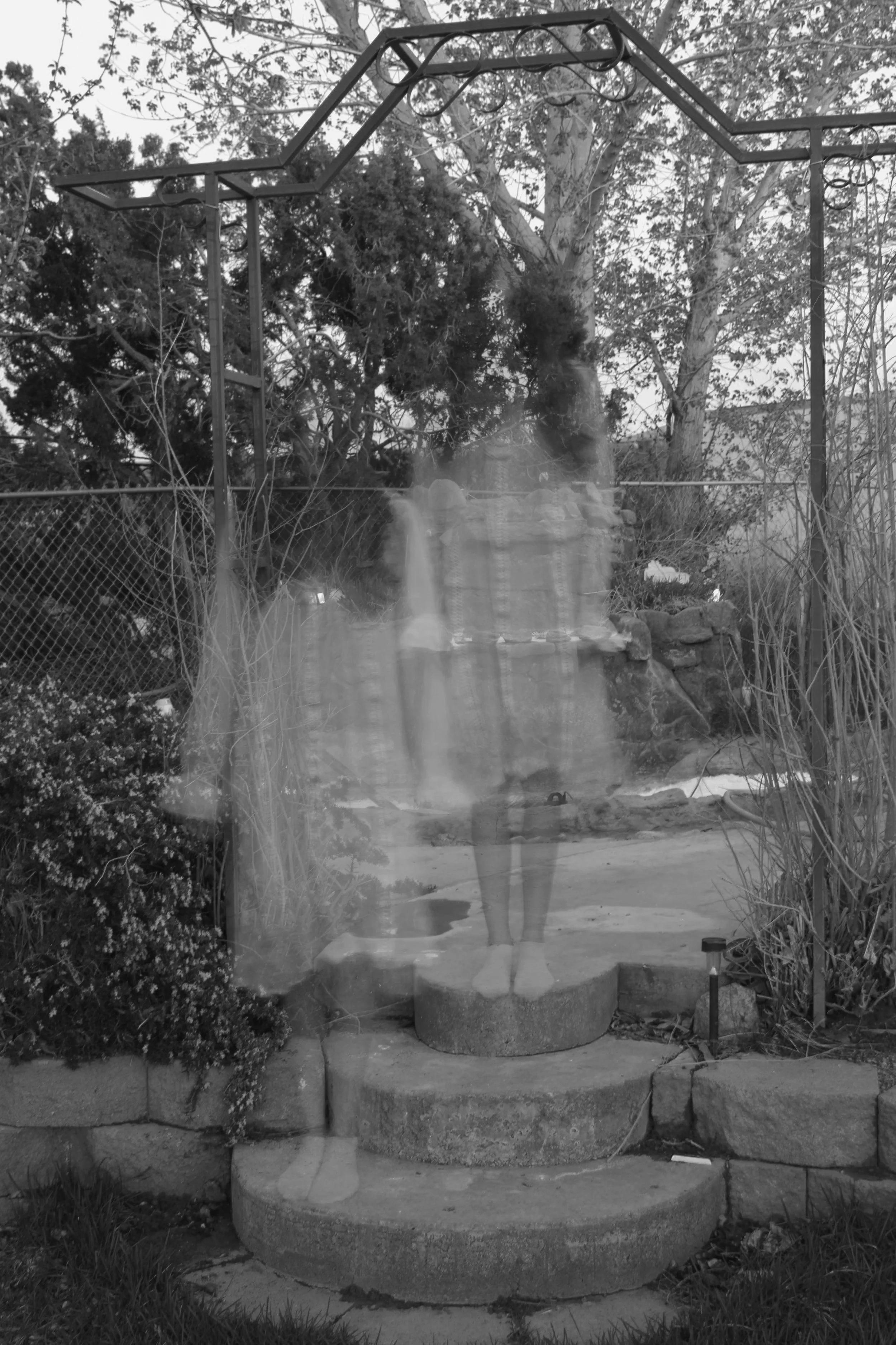 girl is ghosted in a photo to look like twins standing next other eachother, wearing dress, outdoors. dark fantasy fairy photographer.