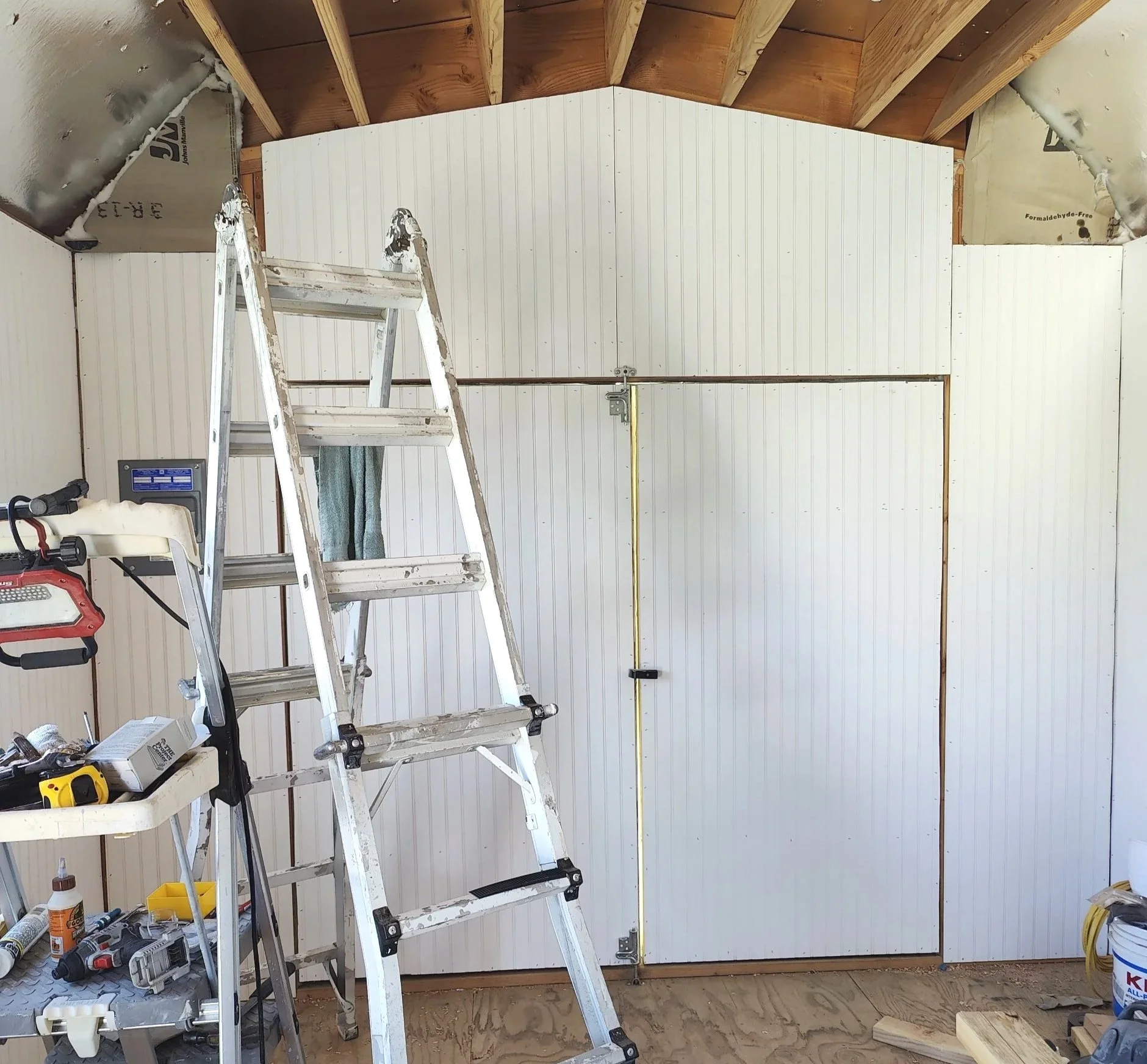 Shed interior with barn doors and gambrel ceiling height from shed world in oak hills, ca.