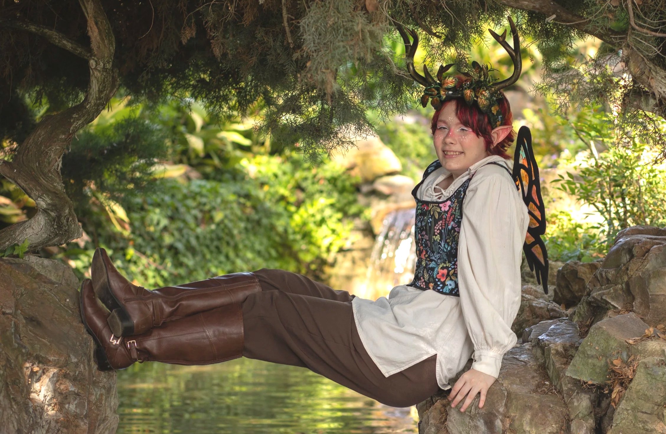 Fantasy setting outdoors with teen model in ten faire costume with wings. Photo by annette marie photography in Whittier, ca.