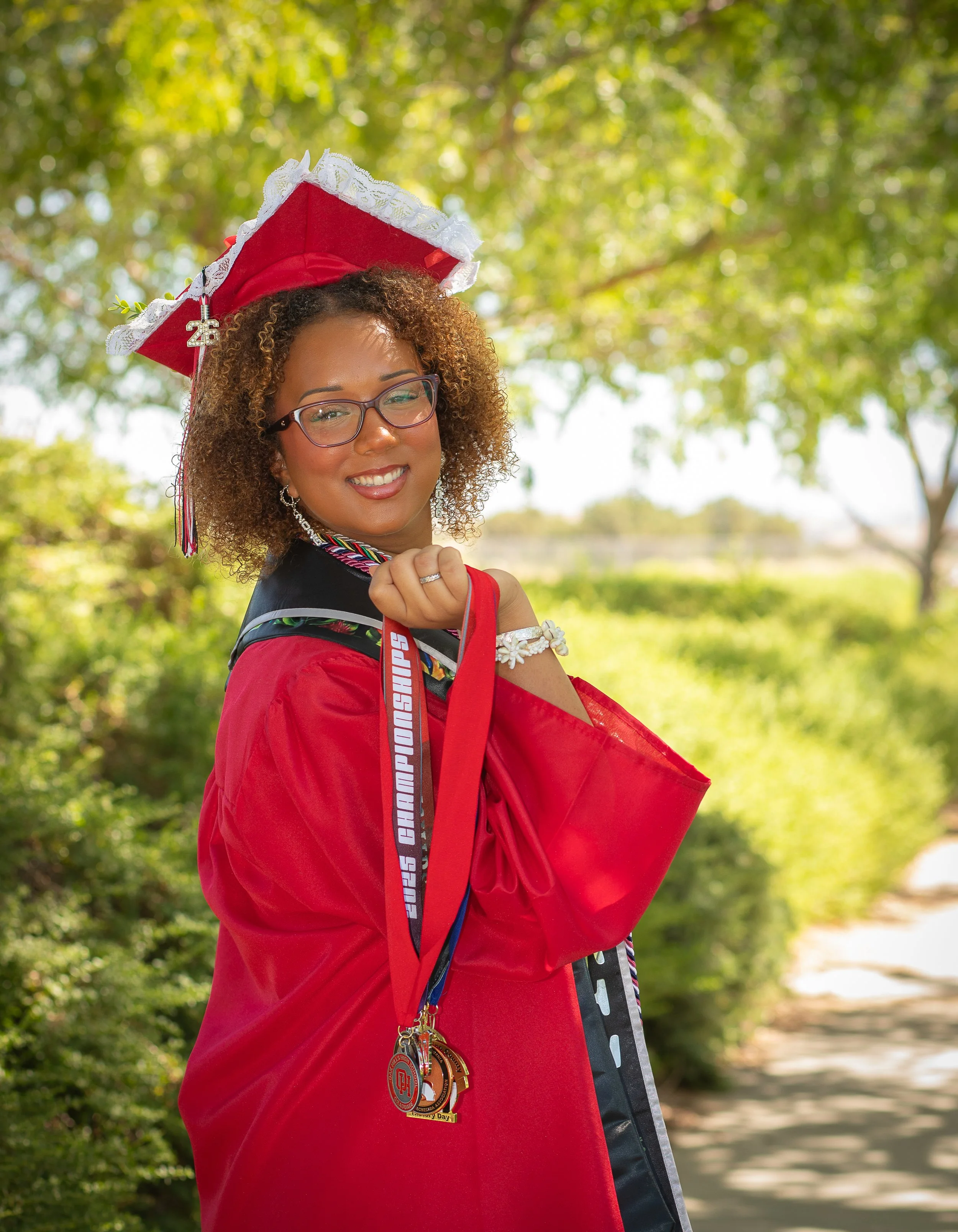 High school graduate with medals and cap and gown, oak hills, ca. 