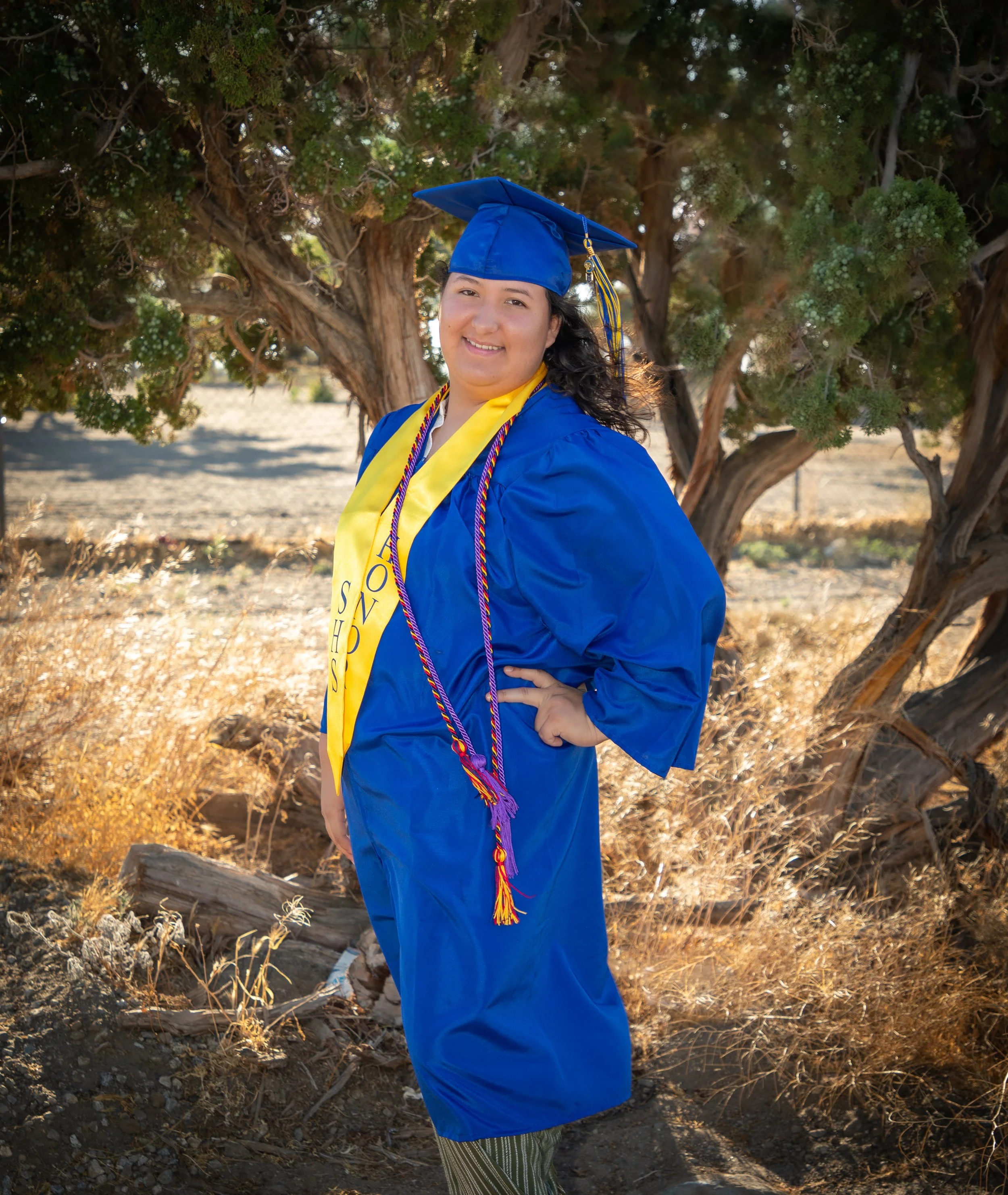 High school graduate in cap and gown, high desert, ca.