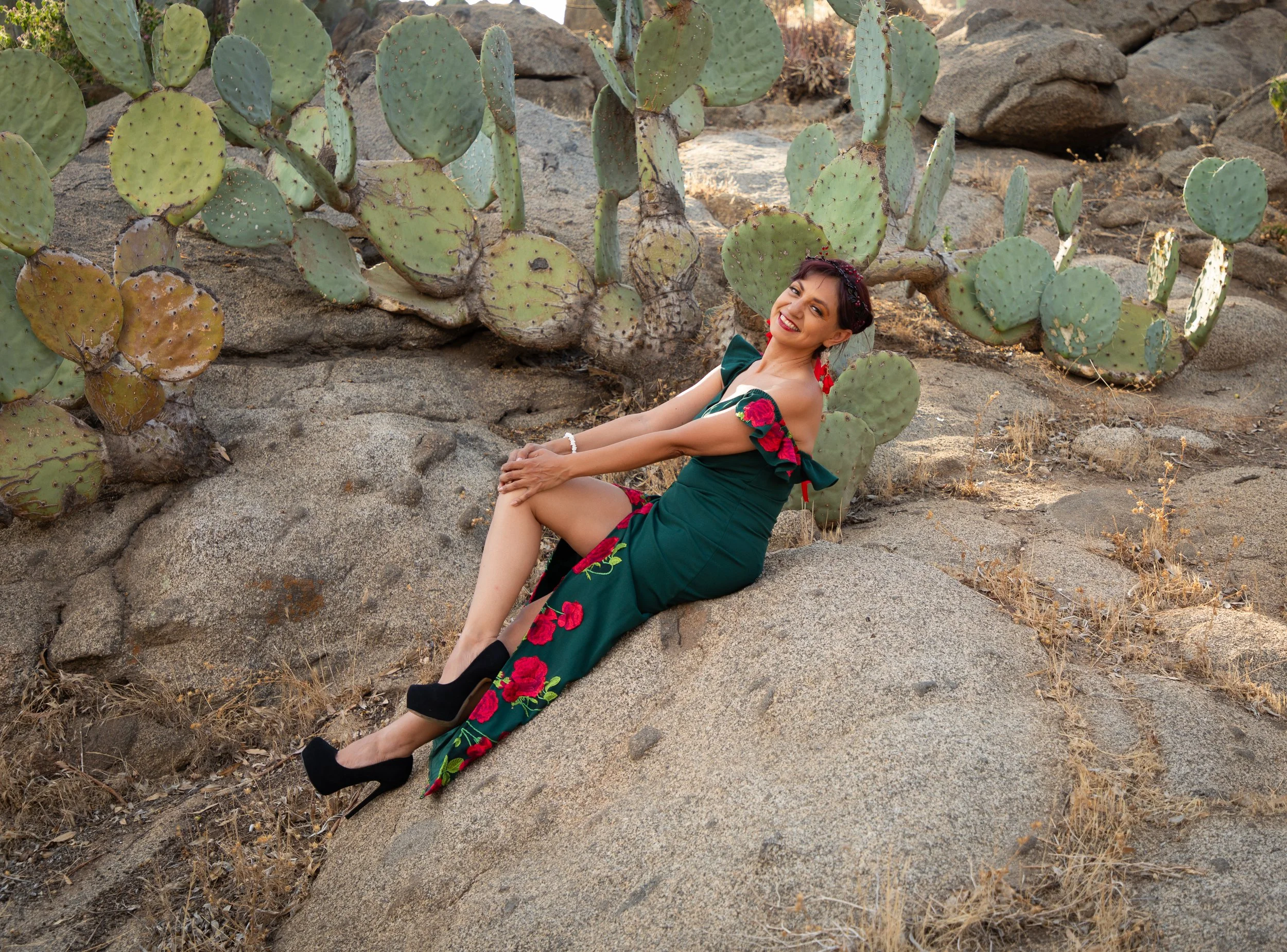 Woman sitting on rocks at Jurupa Valley discovery museum in front of cactus. Fantasy fine art photography by annette marie photography.