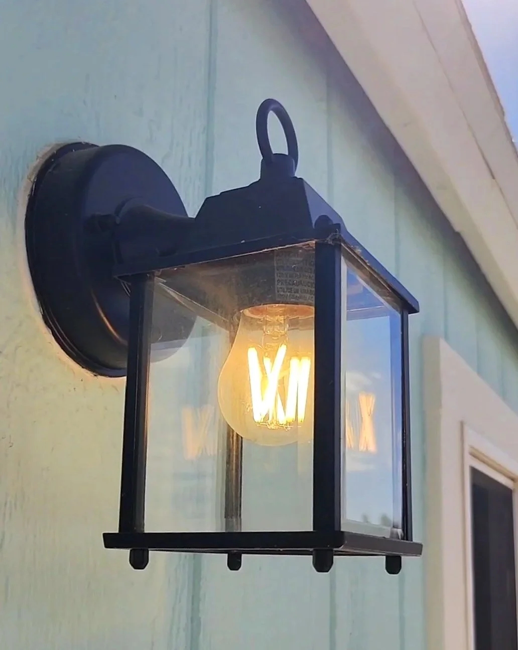 Front porch light on aqua shed that went from backyard eyesore to portrait studio score!
