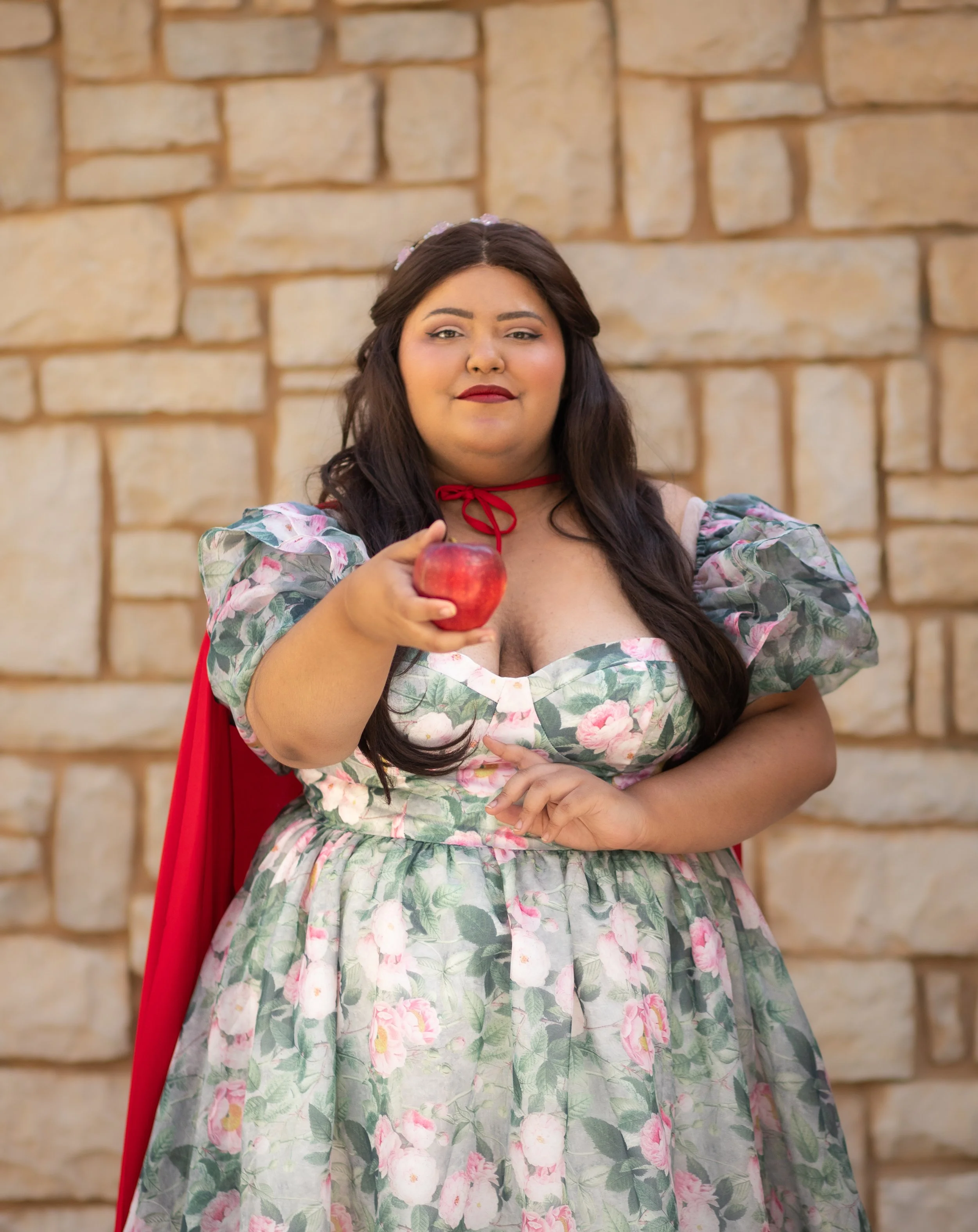photography in the high desert, southern california. Cosplay woman dressed as princess holding a poison apple.