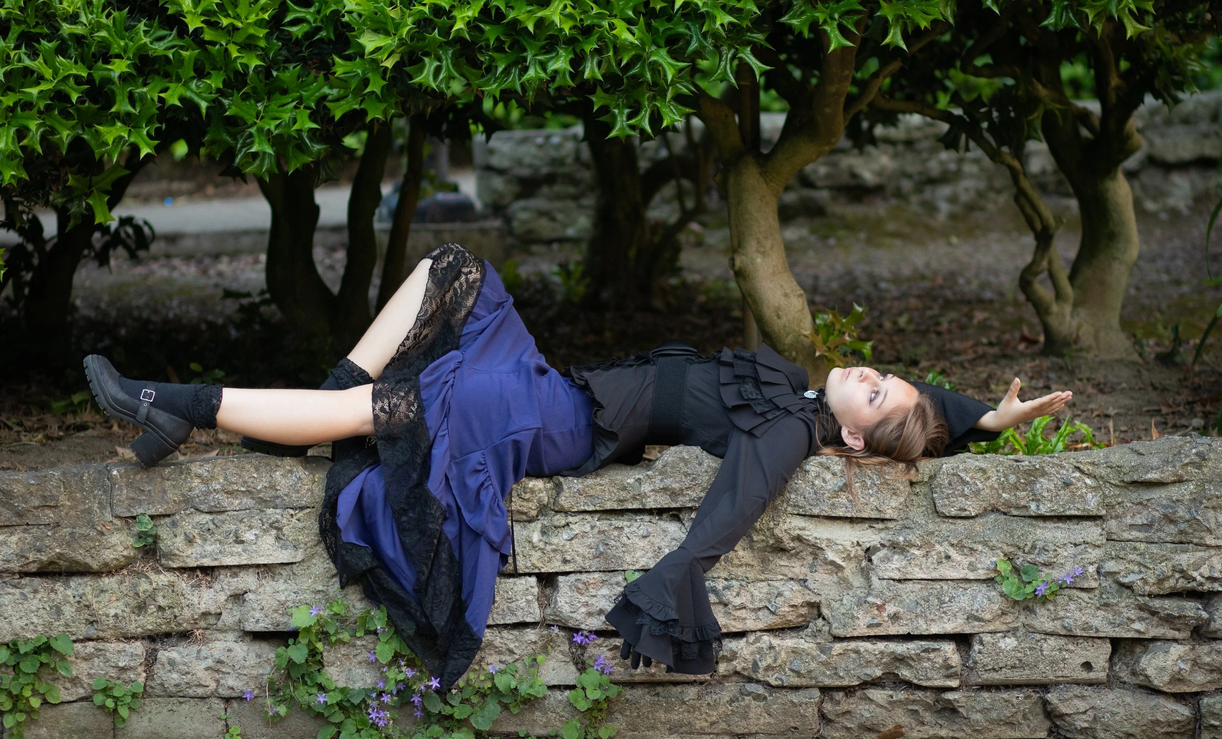 Girl laying on a wall in a forest for an enchanting portrait session by annette marie photograpy in the inland empire, southern california.