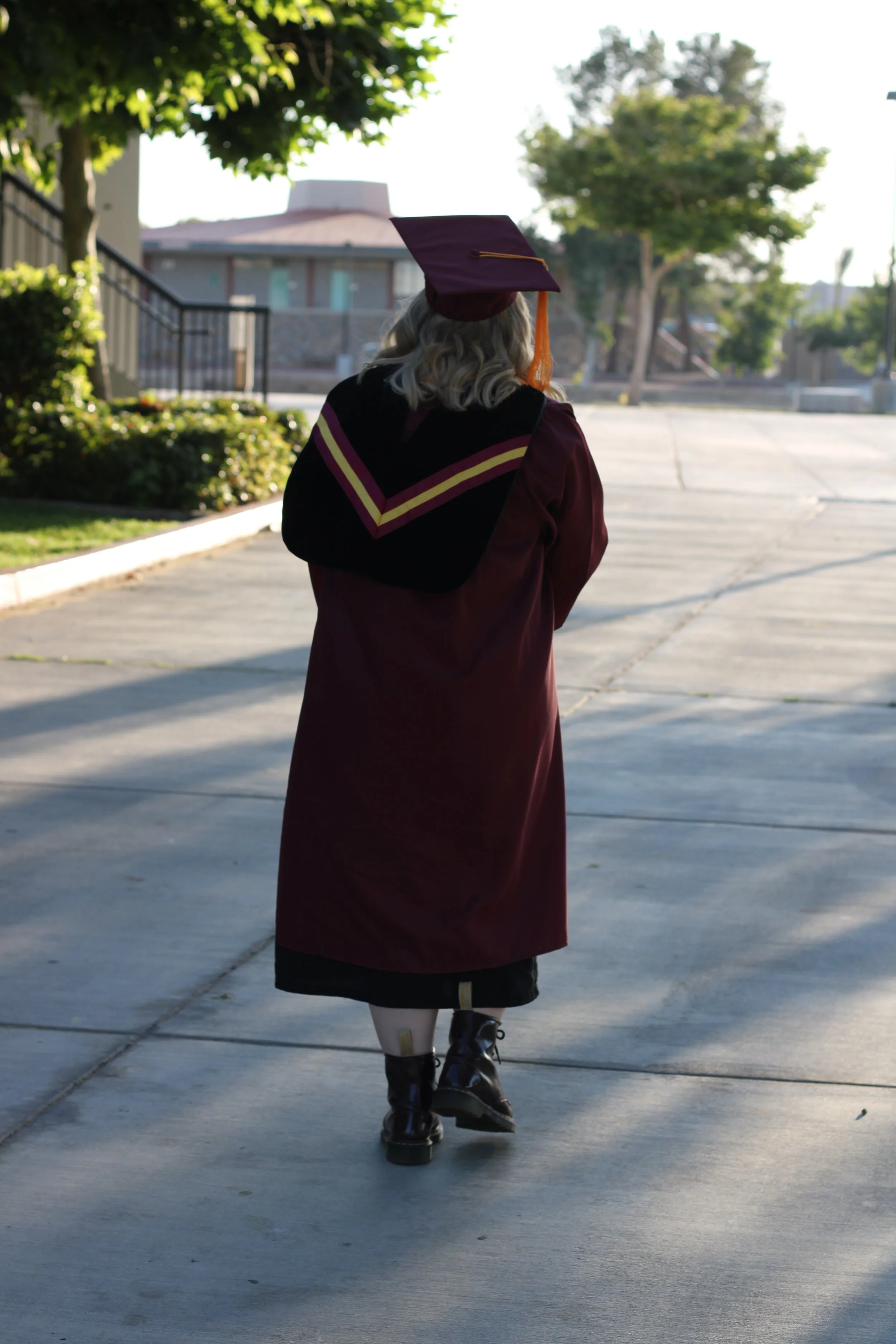 Walking the Victor Valley College campus, graduate photos in cap and gown. Victorville, ca.