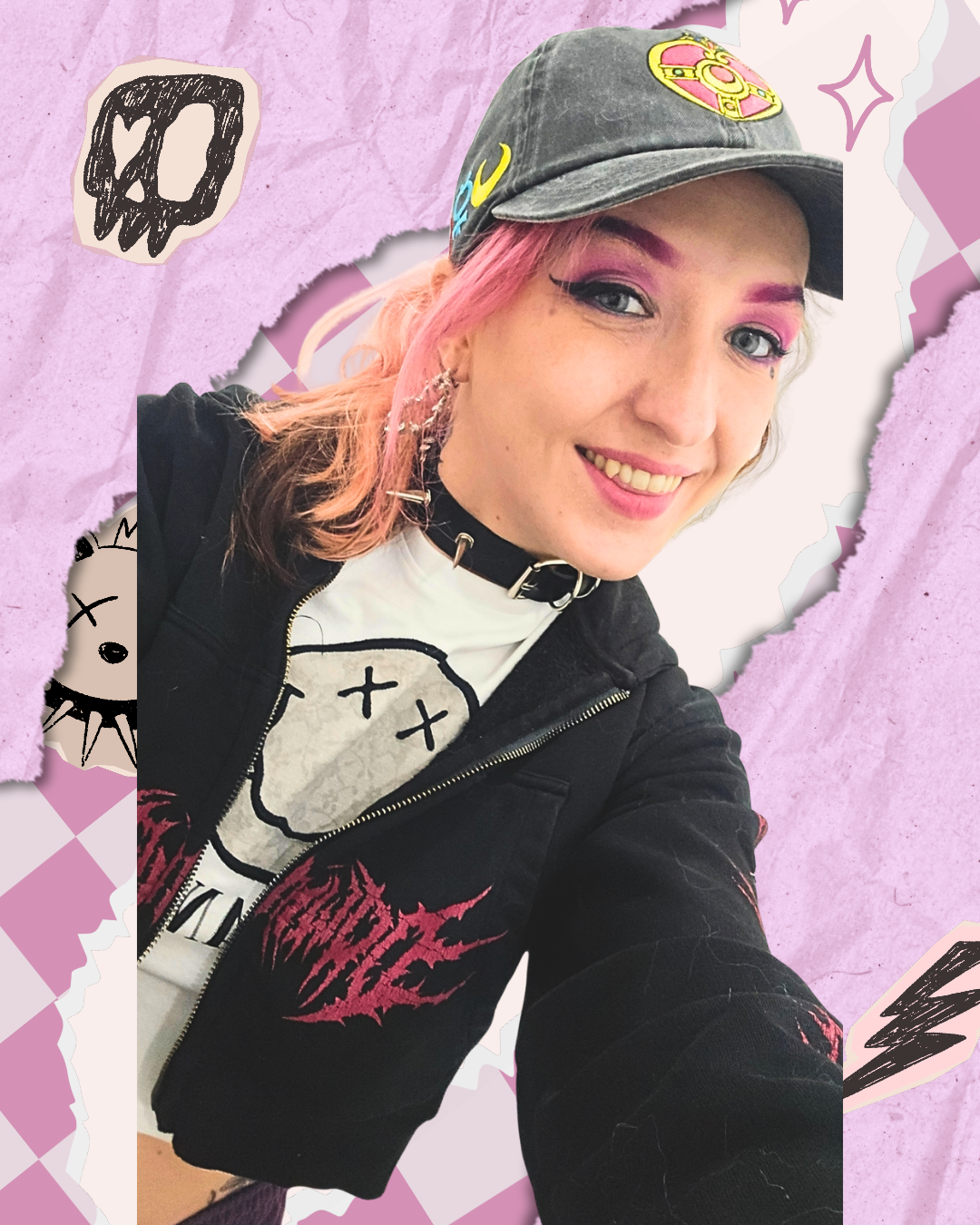 A young woman with pink hair, wearing a black cap with colorful patches, a black jacket with red flame graphics, and a white graphic t-shirt. She is smiling and has pink eye makeup, with a torn paper collage background in pink and purple tones with doodles.