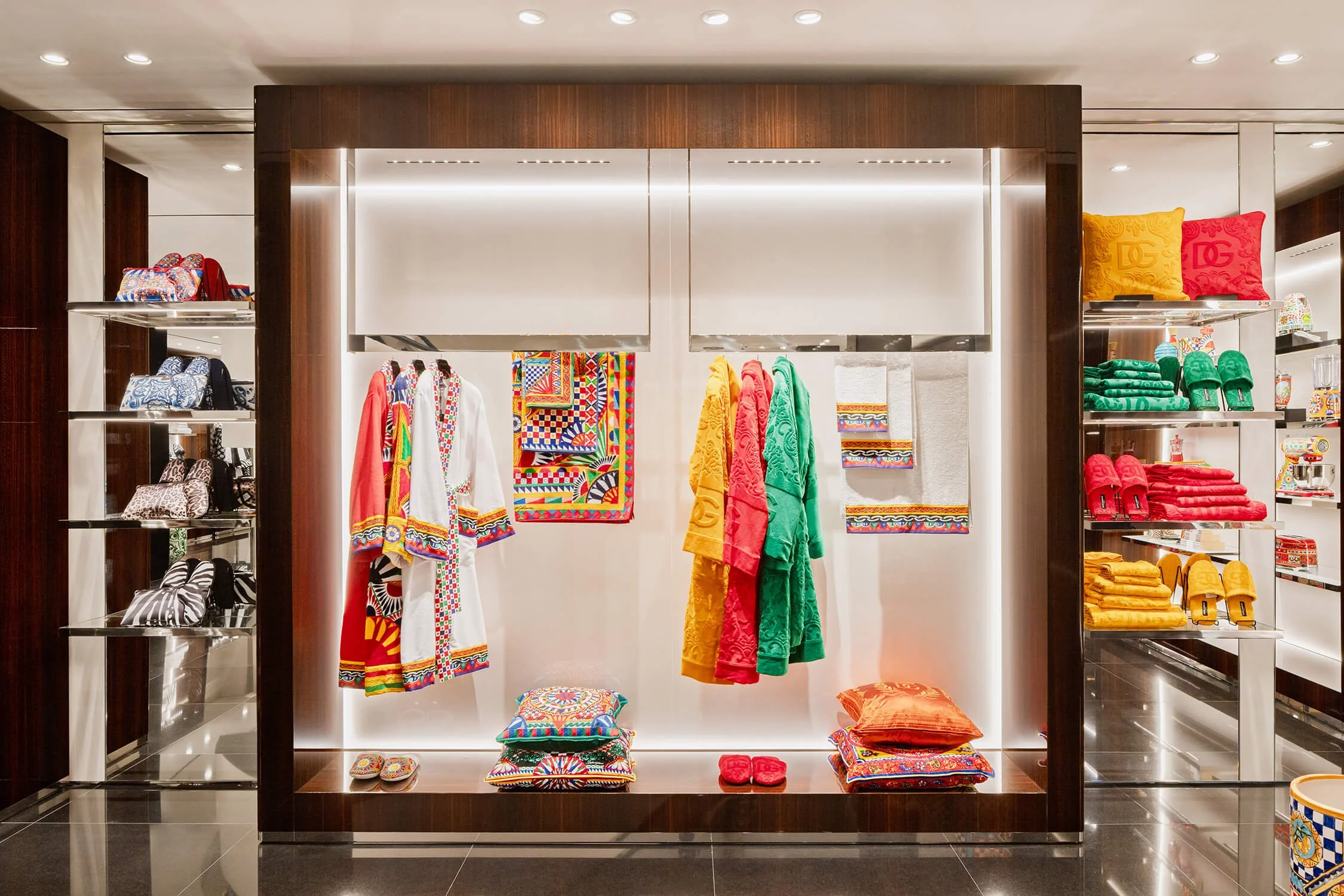 Brightly colored designer robes and accessories in a retail display at Dolce & Gabbana
