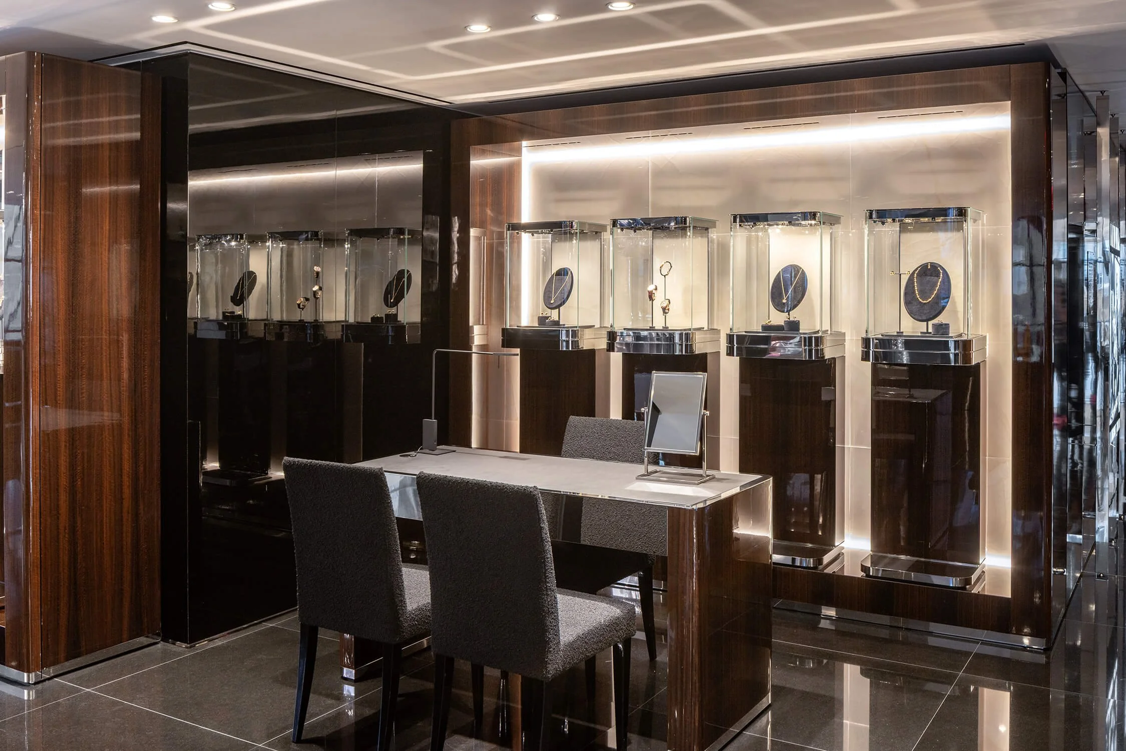 High-end jewelry consultation area with display cases and chairs in Dolce & Gabbana boutique
