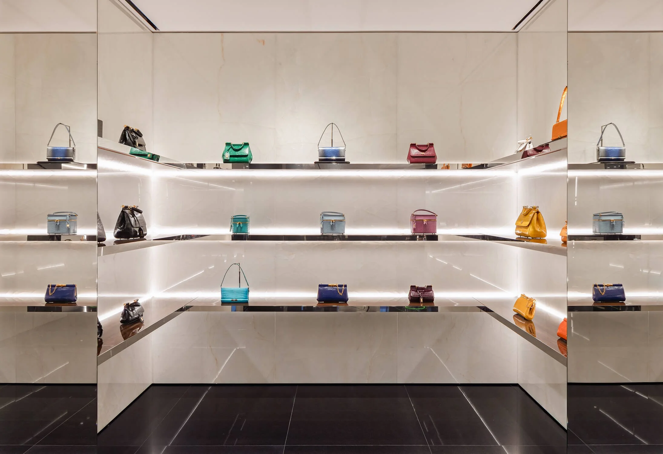 Luxury handbag display in minimalist lighting inside Dolce & Gabbana retail environment
