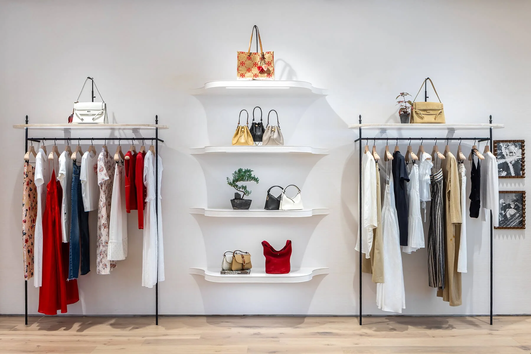 Scarf and accessory corner at the Tory Burch Americana Manhasset store, with a framed silk scarf, dress forms, and layered prints
