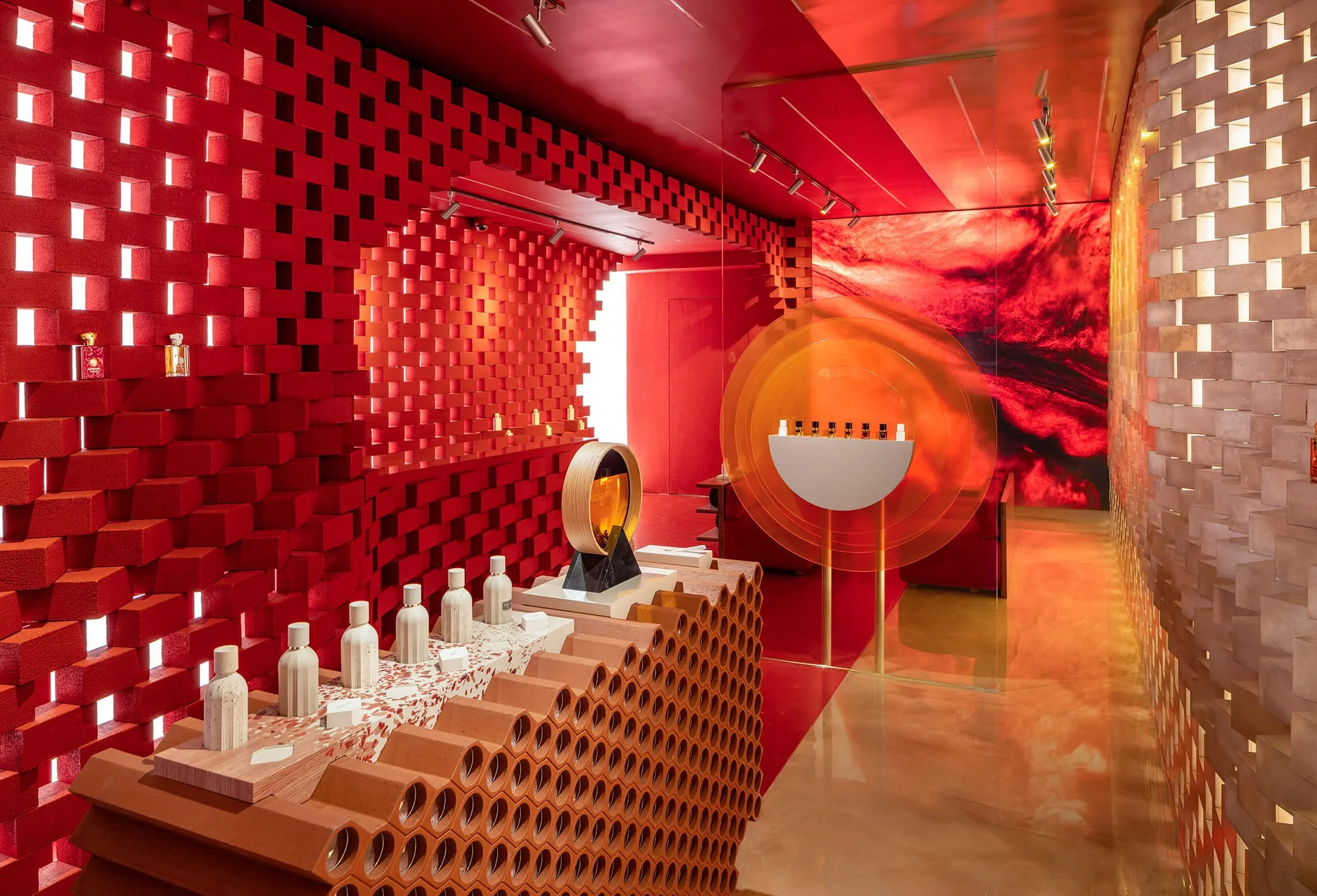 Contemporary retail space at Amouage Soho with red architectural details, captured for The Retail Archive, retail store photographers.