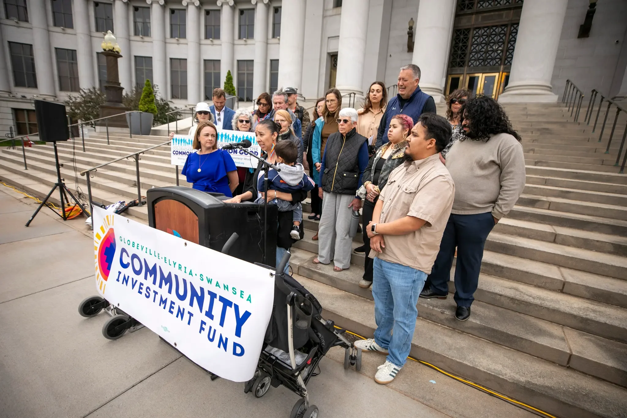 The Globeville Elyria Swansea Community Investment Fund volunteer on city council steps