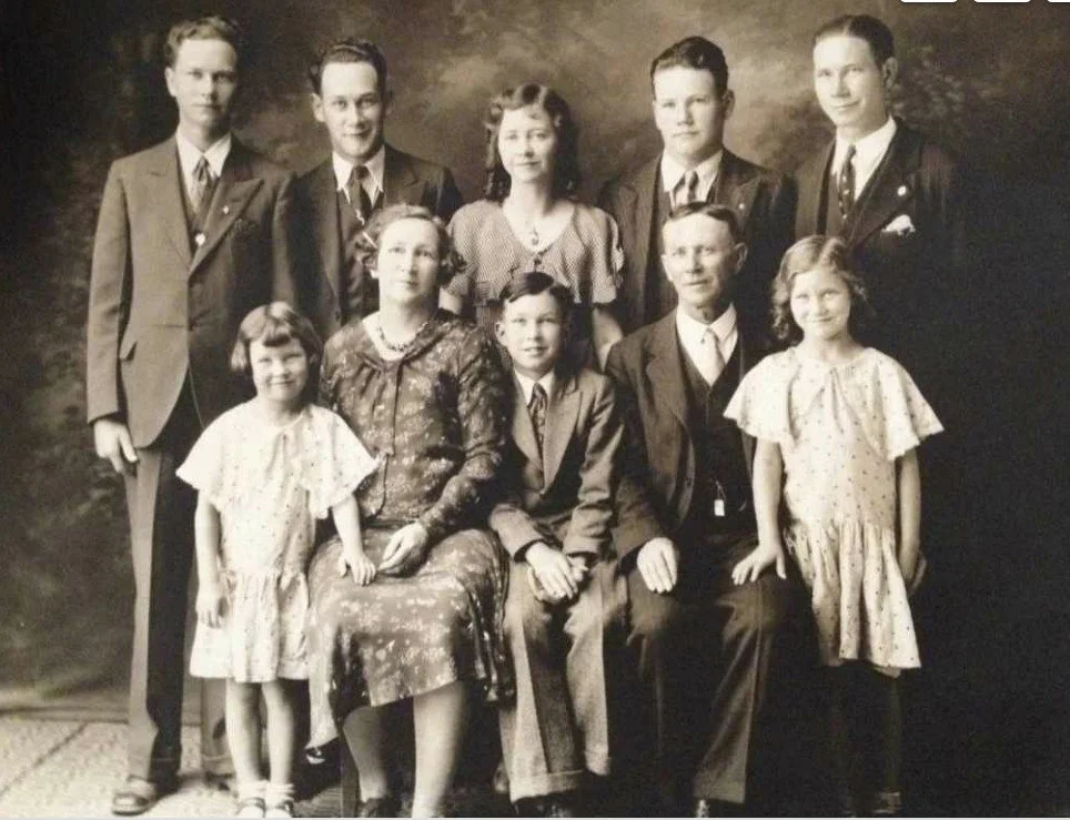 William seated with his wife and children. Date unknown.